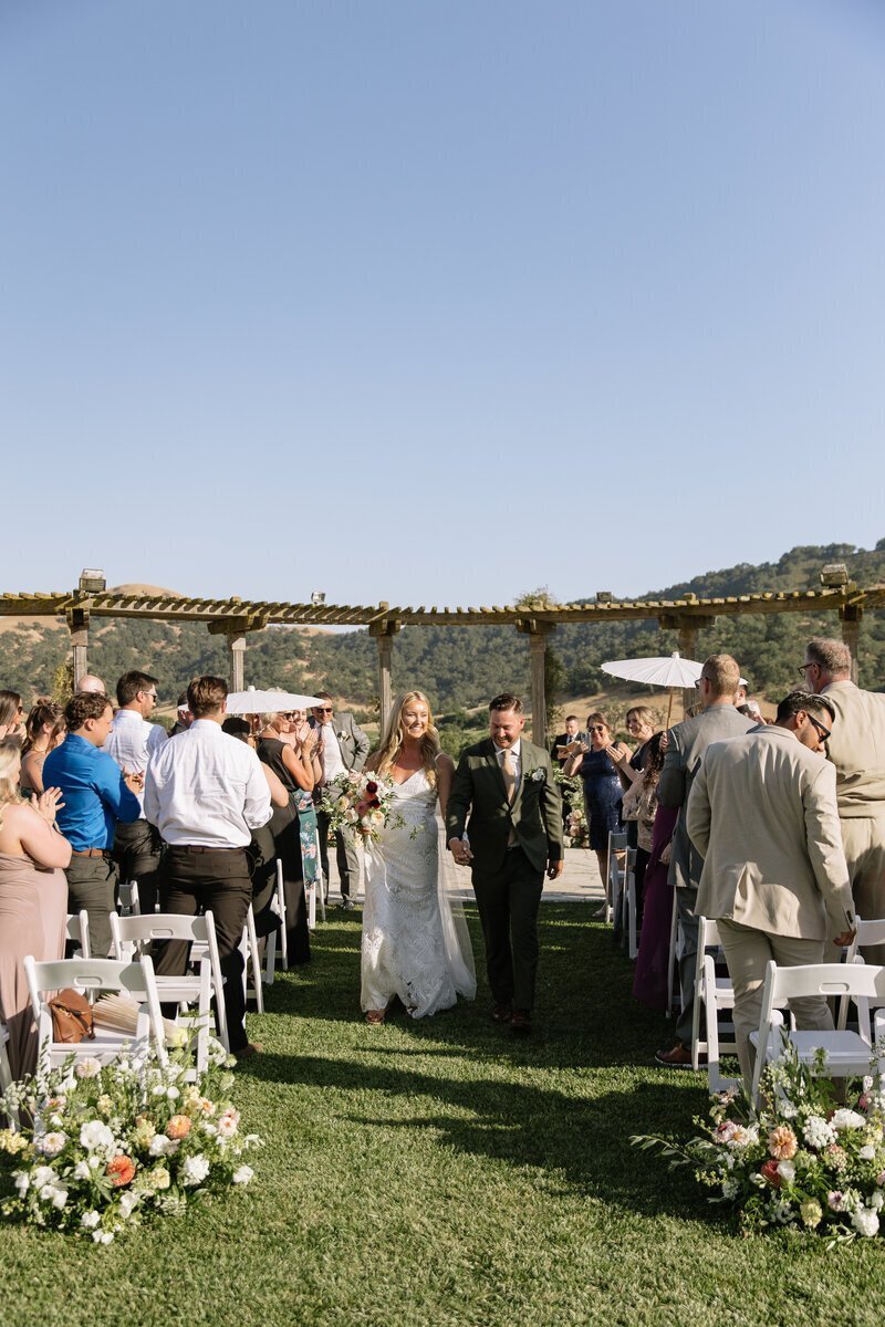 Bride and groom walking down aisle by wedding photographer northern california