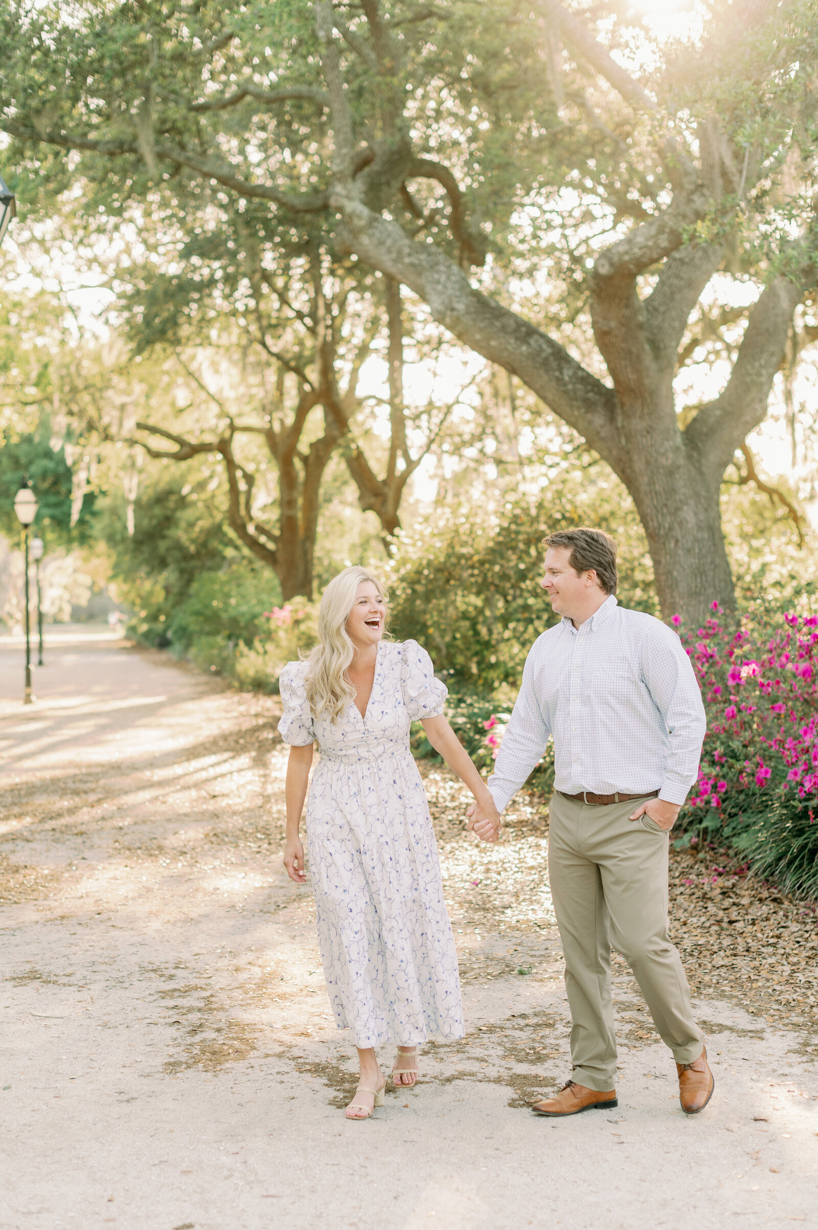 Couple walks and laughs through the sunset at their Hampton Park Engagement Session