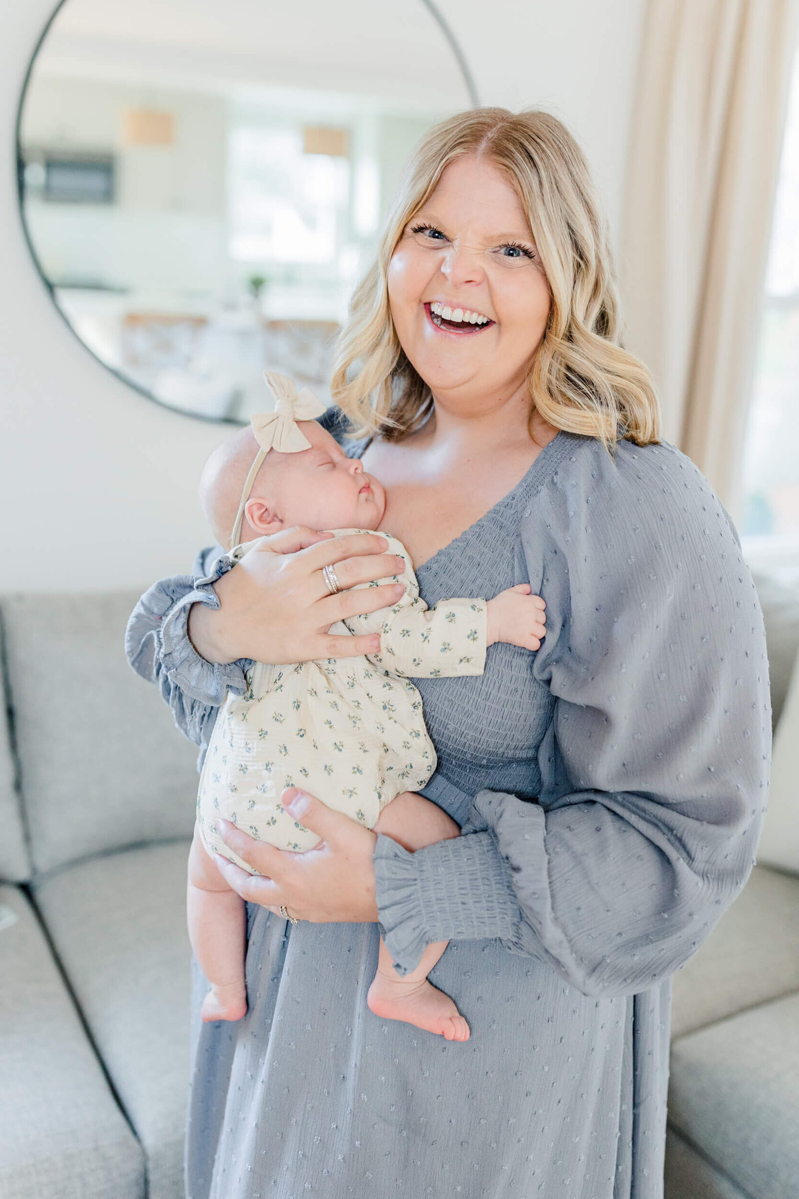 Mom smiles and holds her newborn