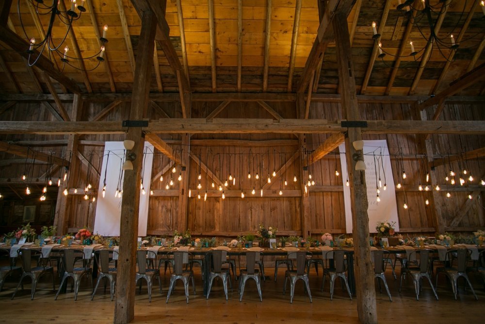 Gorgeous rustic tablescape for barn wedding with Edison Bulb light installation at The Barn on Walnut Hill