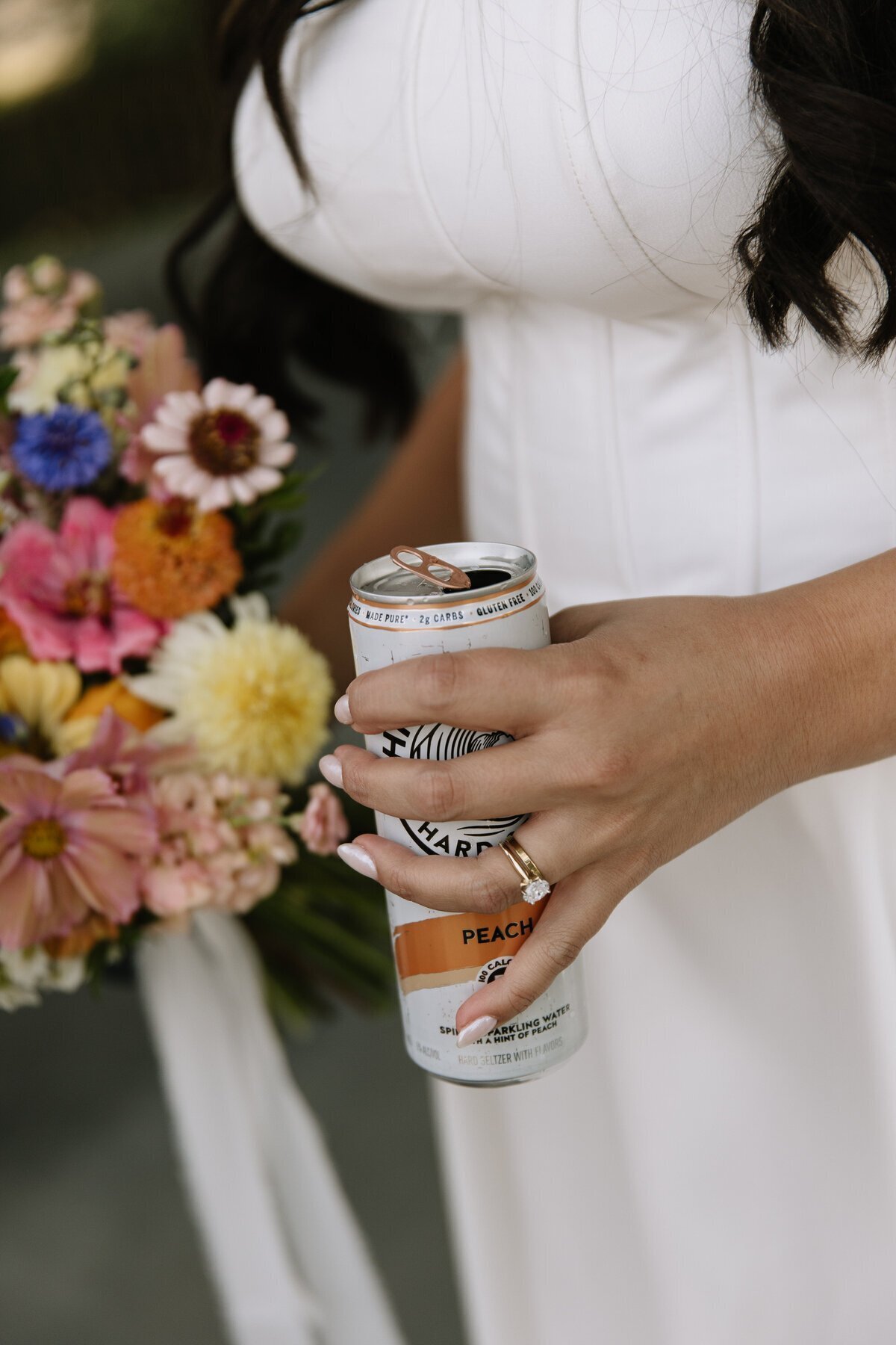 Bride holding bouquet and white claw by destination wedding photography