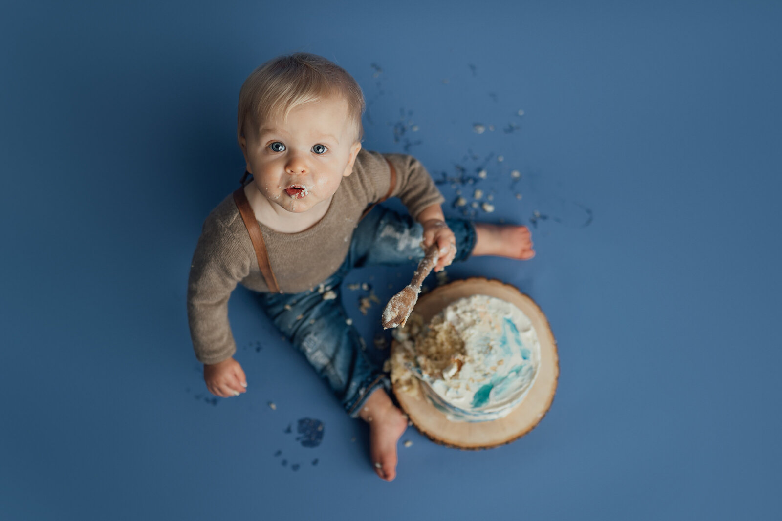 Boy eating cake during studio cake smash photography session in St. Pete