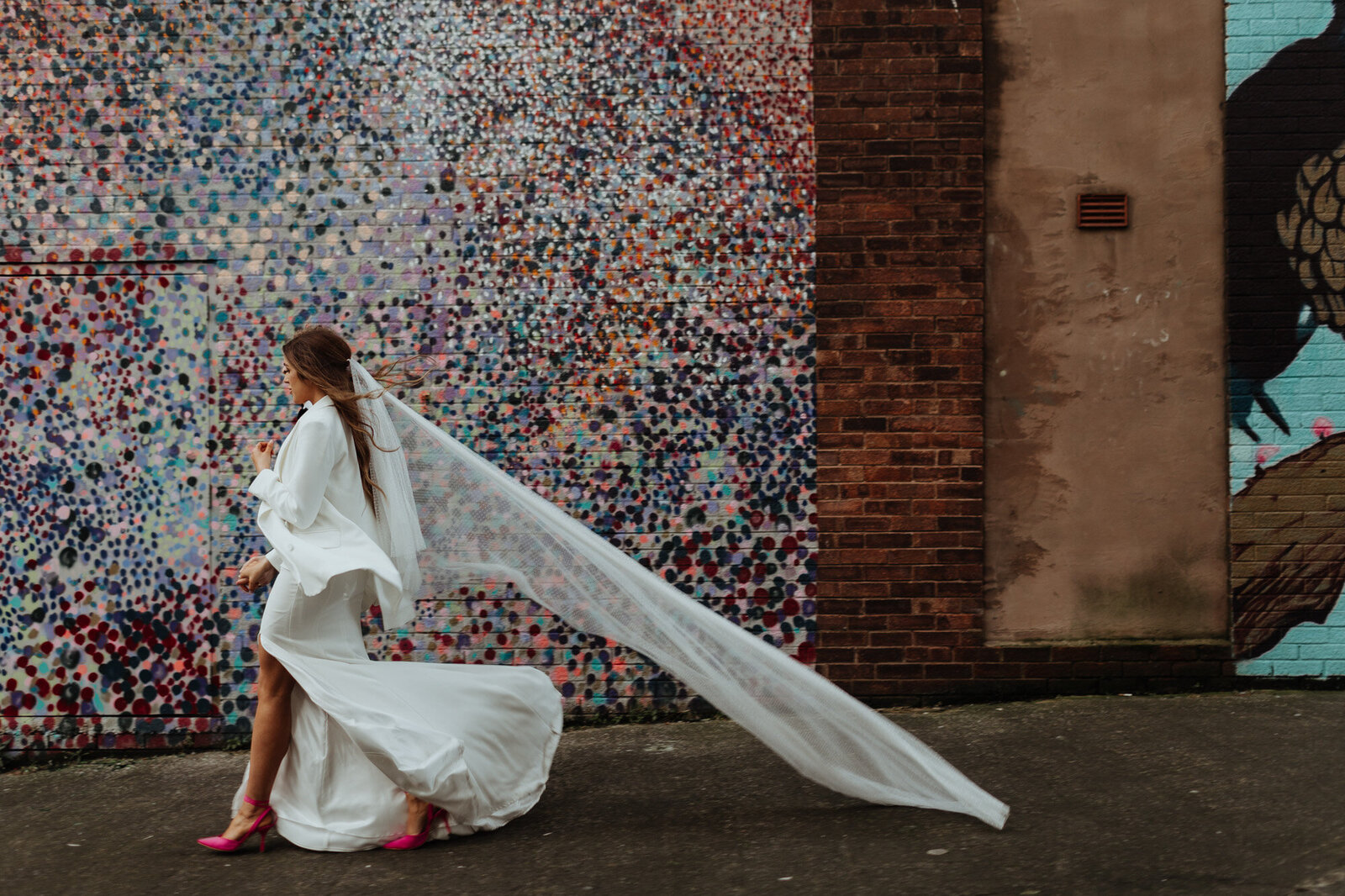 bride walking with train blowing in wind
