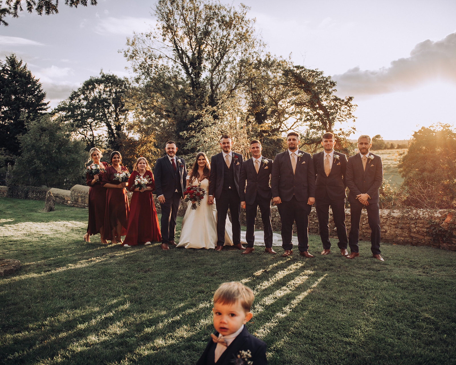 Sunset group shot interrupted by bride and groom's son