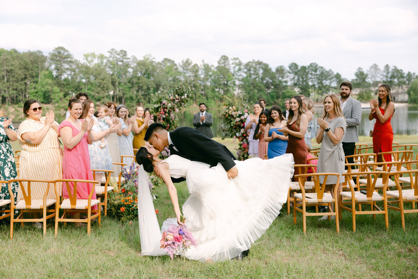 dip kiss of bride and groom at ceremony recessional