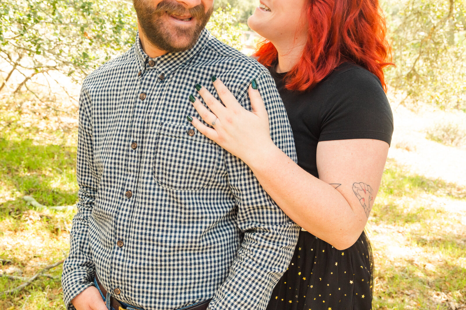 An tattooed engaged couple poses for photos in a redwood forest in Santa Cruz, Ca.