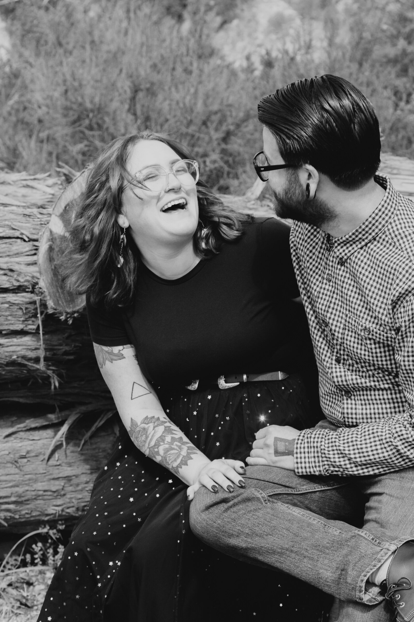 An tattooed engaged couple poses for photos in a redwood forest in Santa Cruz, Ca.