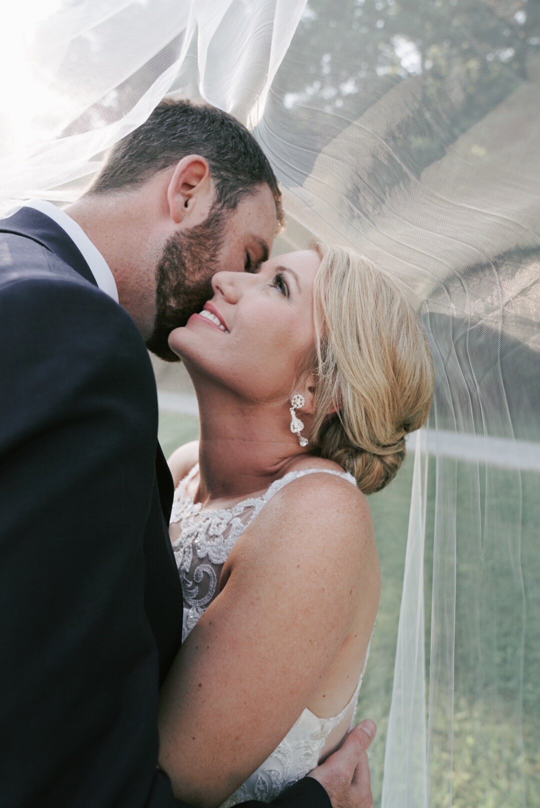 Intimate veil kiss bride groom tennessee farm smoky mountain wedding barn reception outdoor