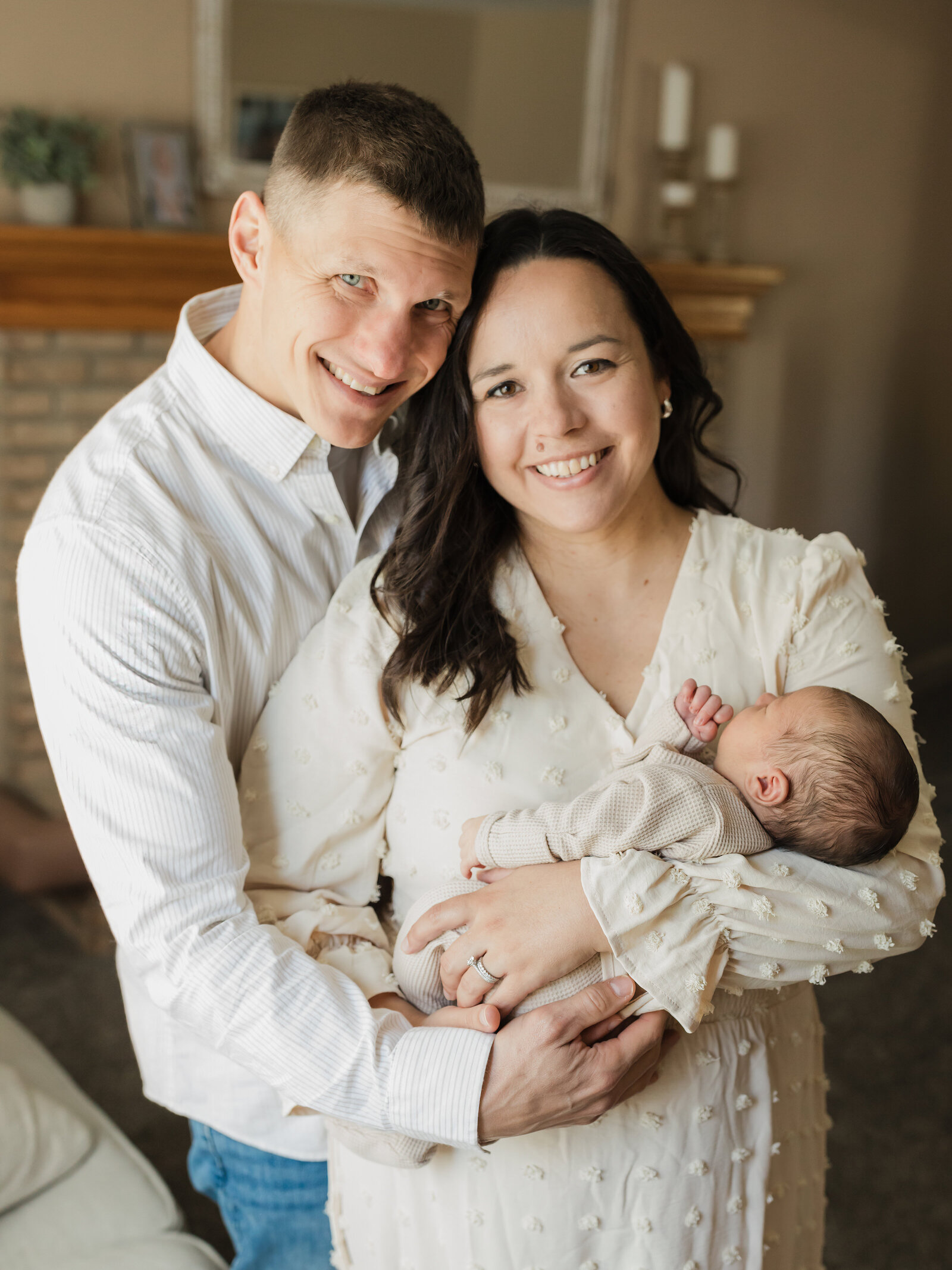 mom and dad holding newborn baby boy for in home newborn session
