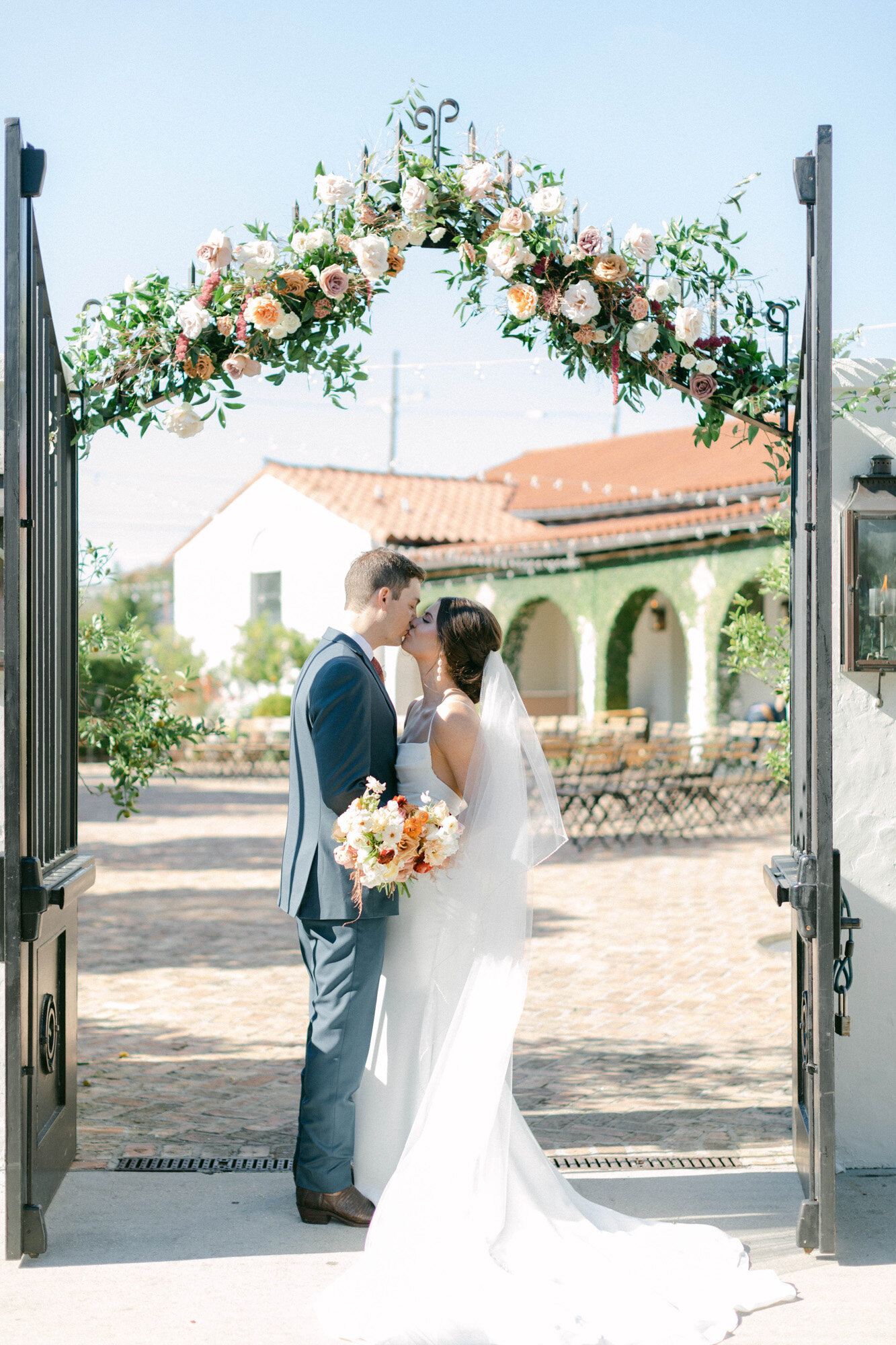 bride and groom standing in gate at wedding in New Orleans