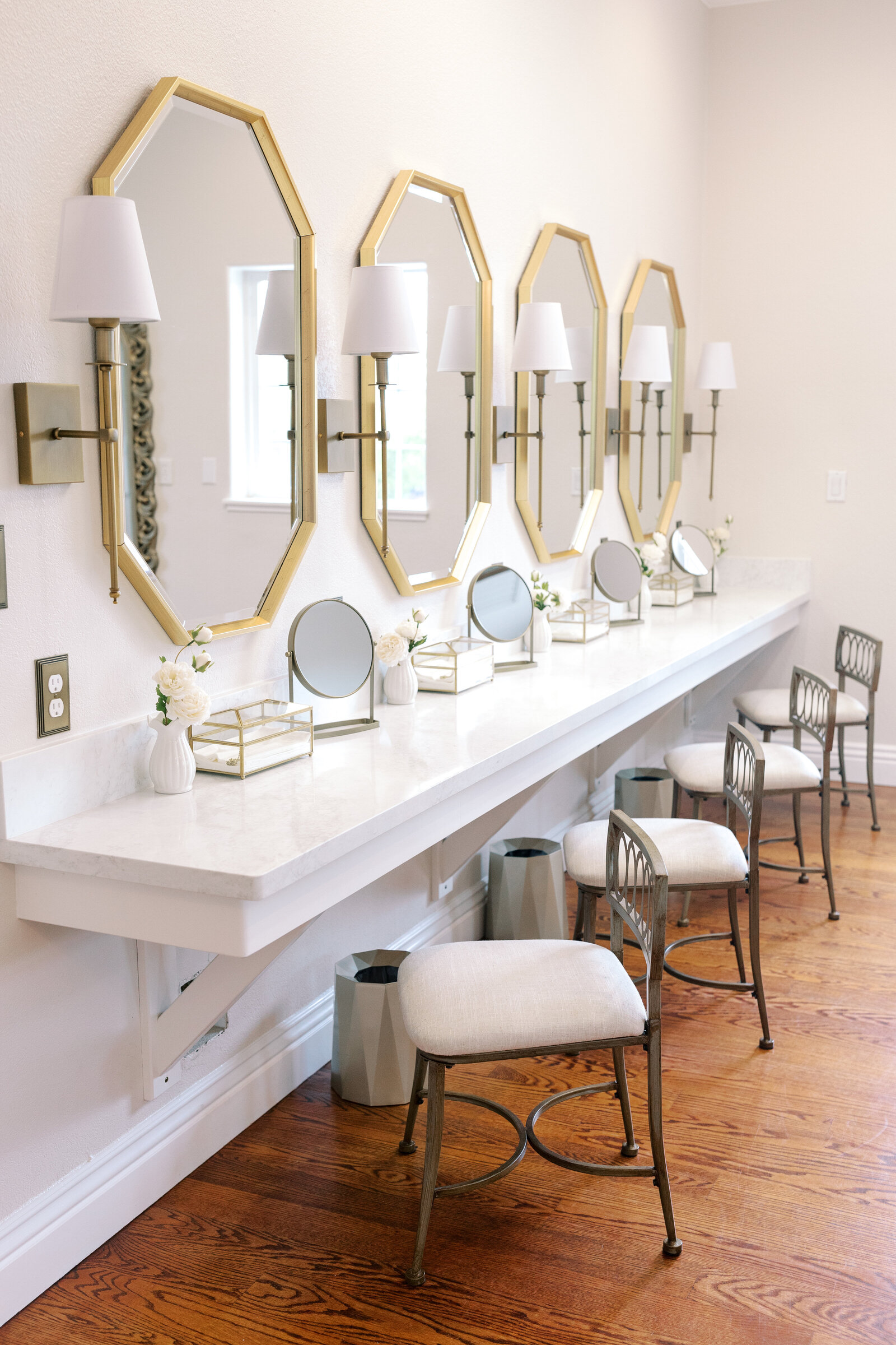 bridal suite in Wolfe Heights with multiple mirrors and chairs lined up for bridesmaids and bride  captured by sacramento wedding photographer