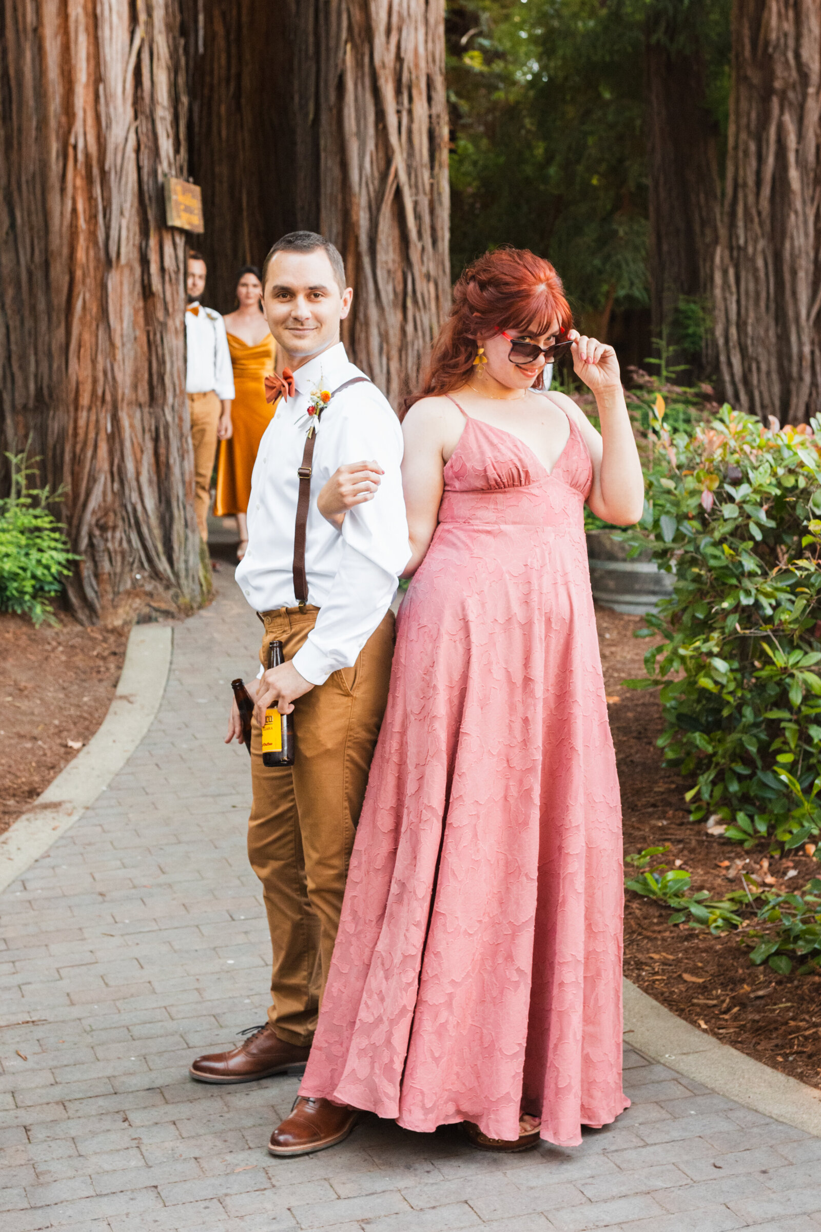 Bridal party at a colorful wedding ceremony in Santa Cruz, California in the redwood trees.