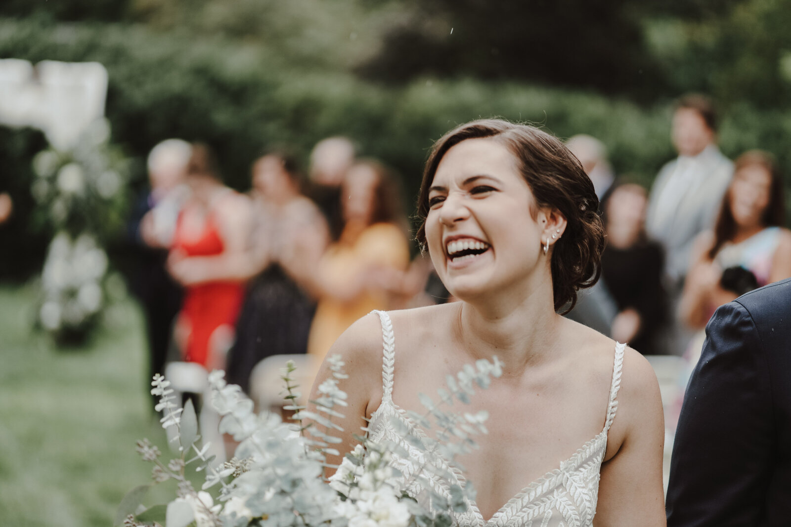 A bride smiles as she walks up the aisle