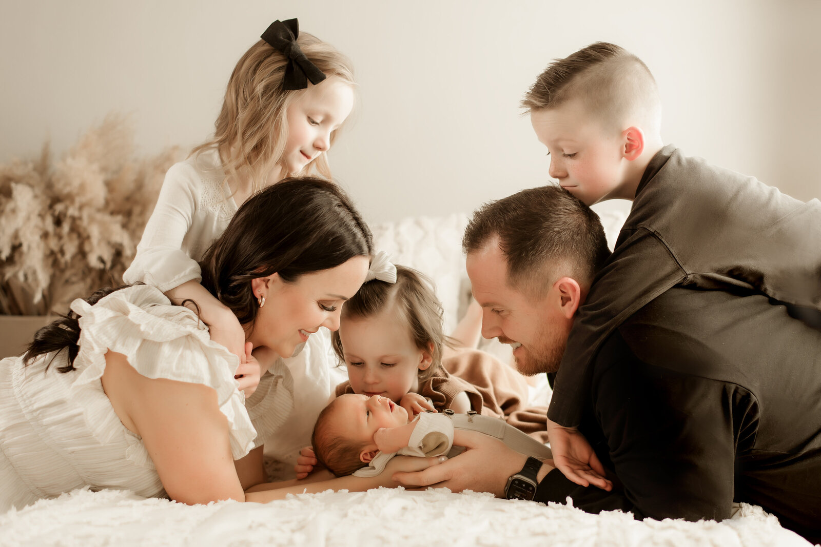 posing for indoor lifestyle family photoshoot with a baby