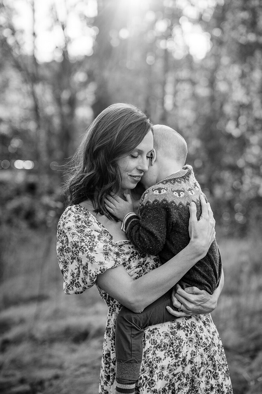 black and white portrait of a mother holding her toddler son close