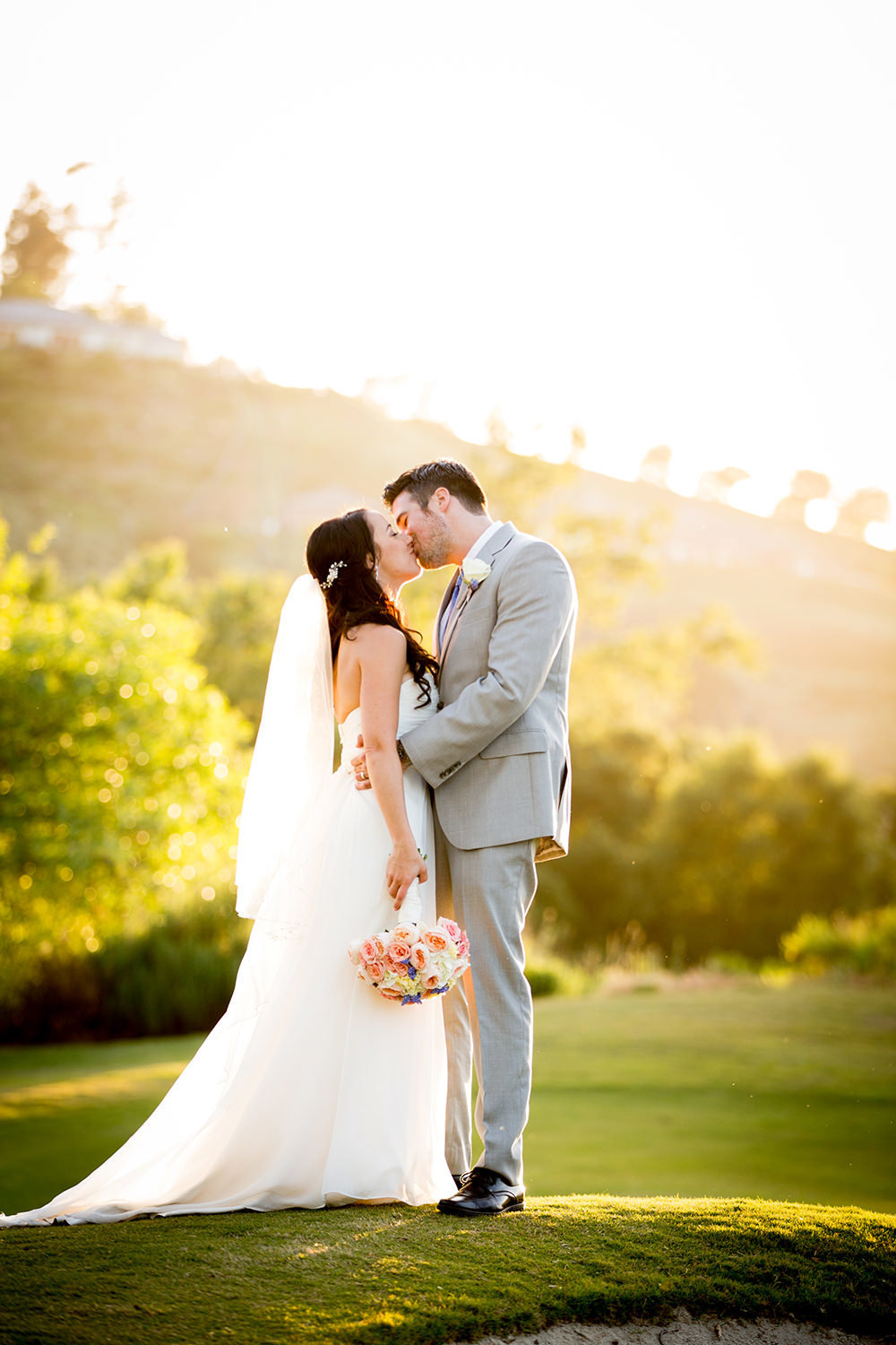 bride and groom kissing with stunning light