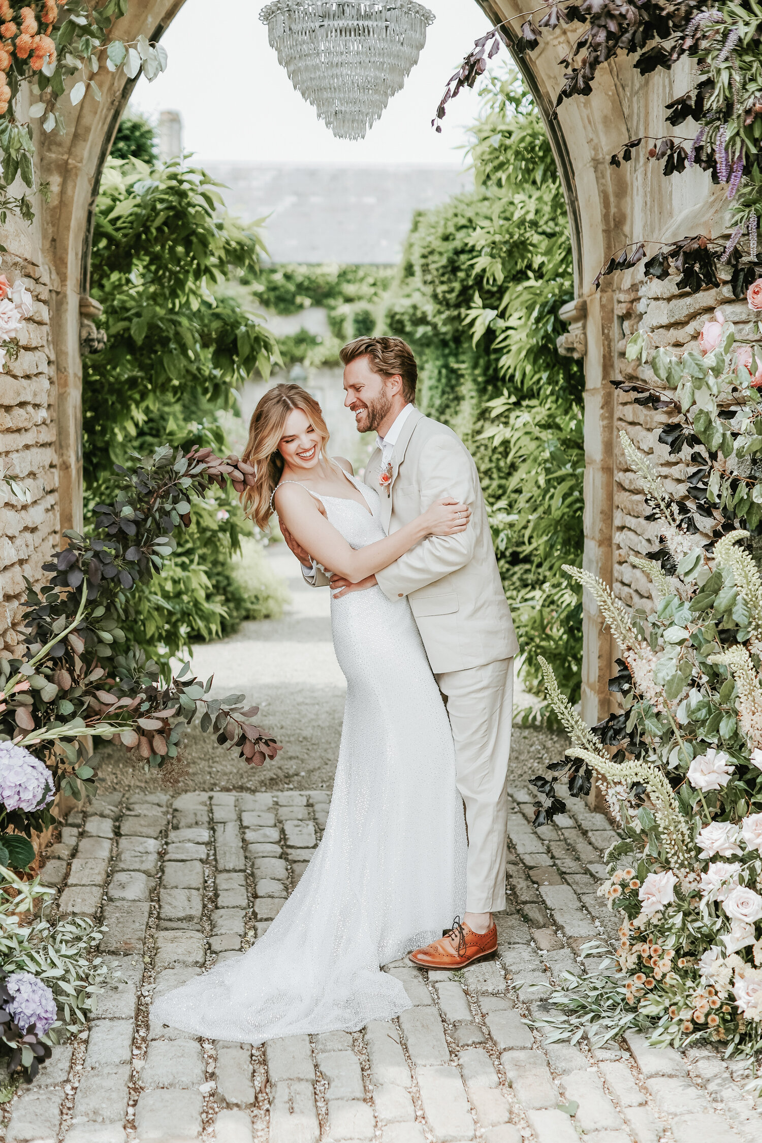 Euridge-Manor-wedding-bride-and-groom-under-floral-archway
