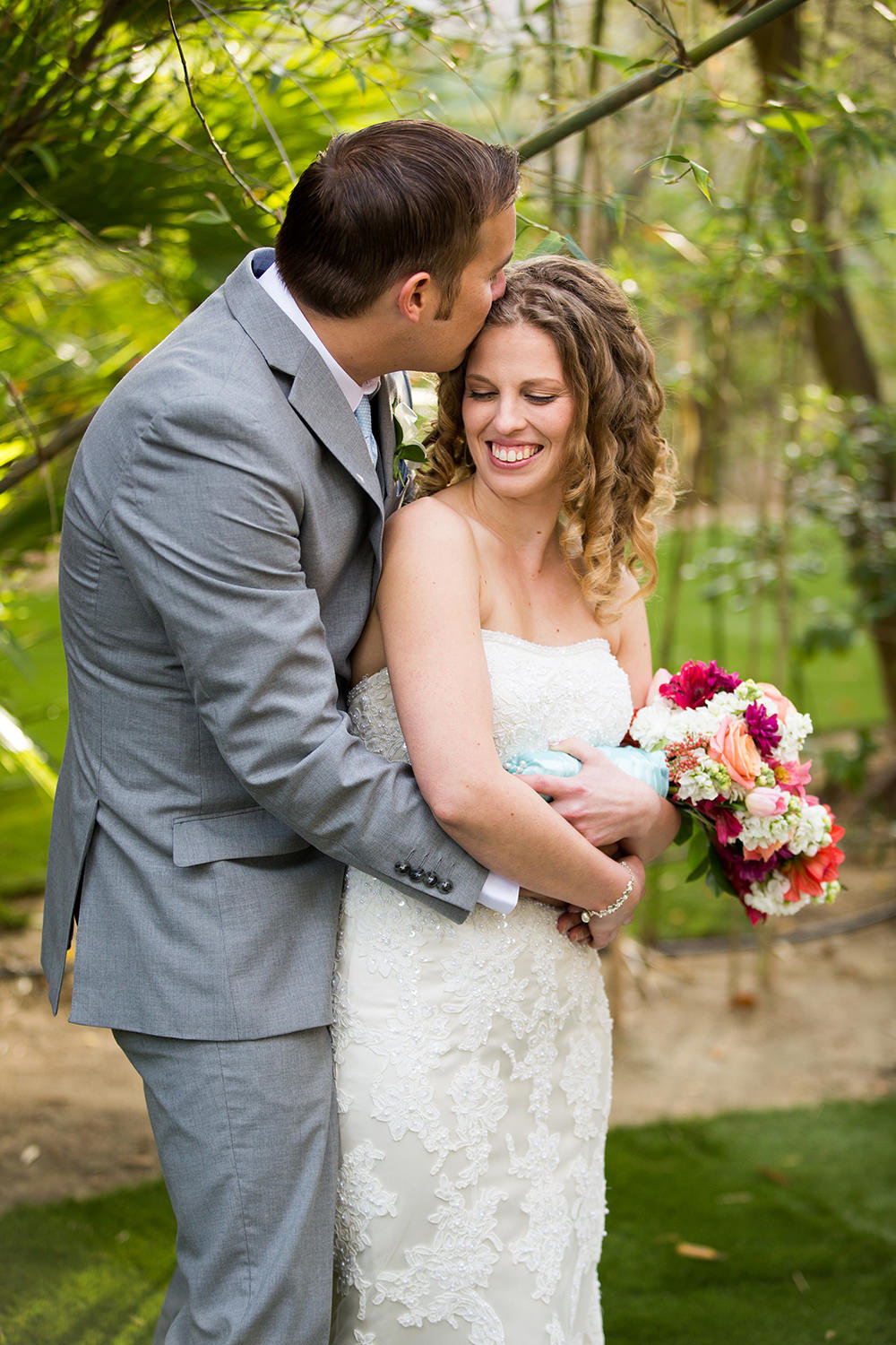 groom kissing brides forehead