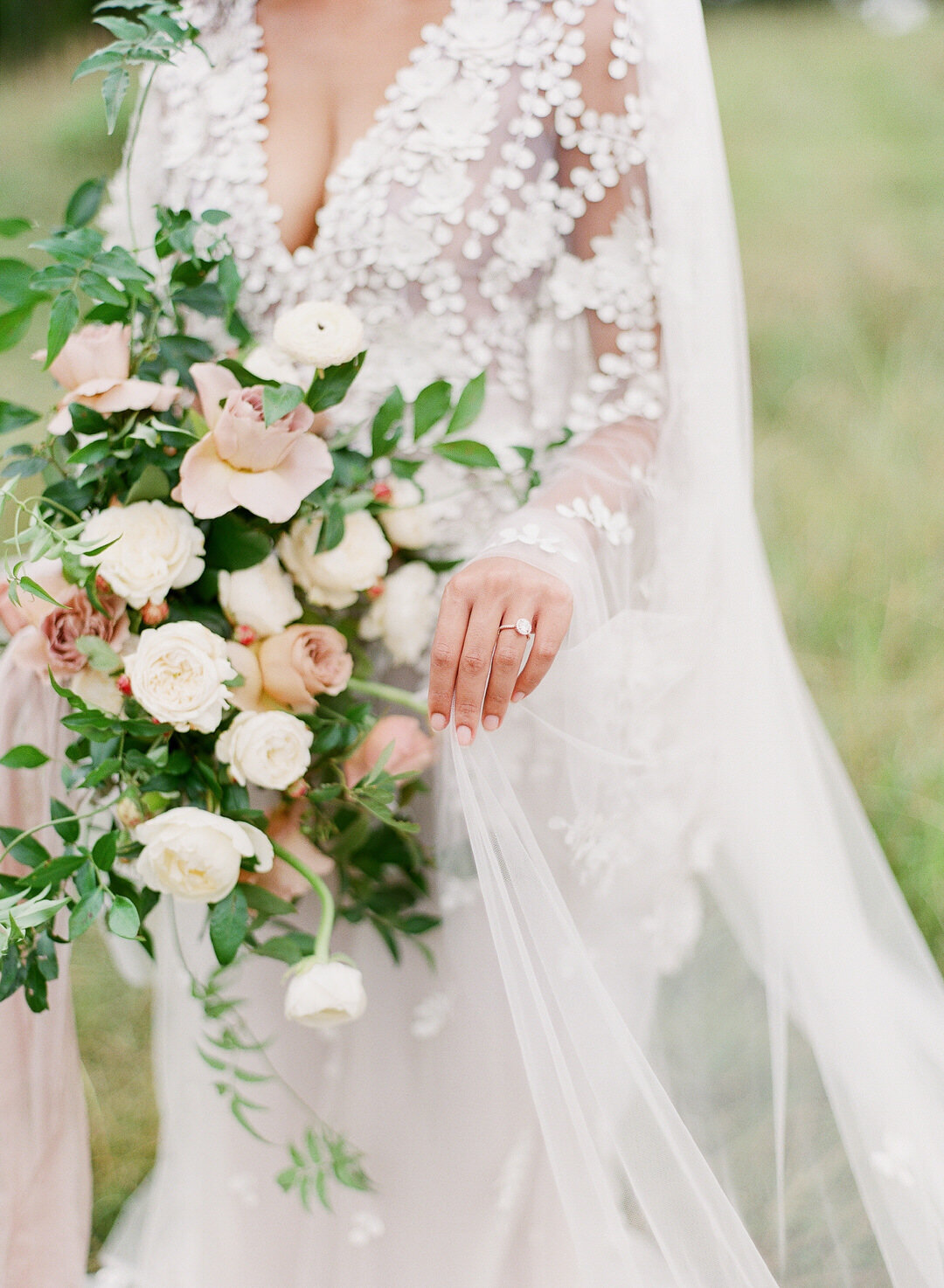 Bride holding bouquet and veil