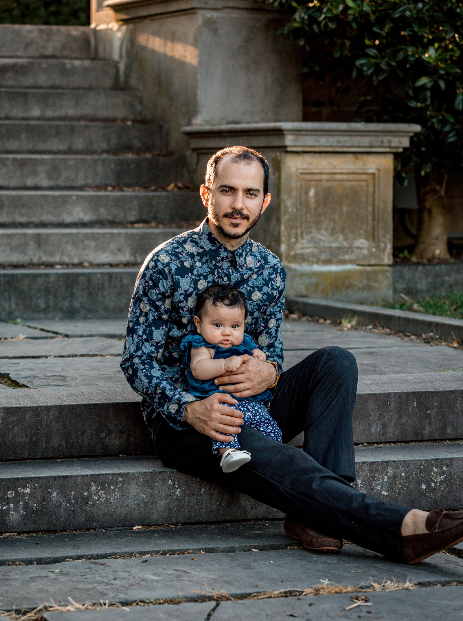 dad sitting on stairs with his baby