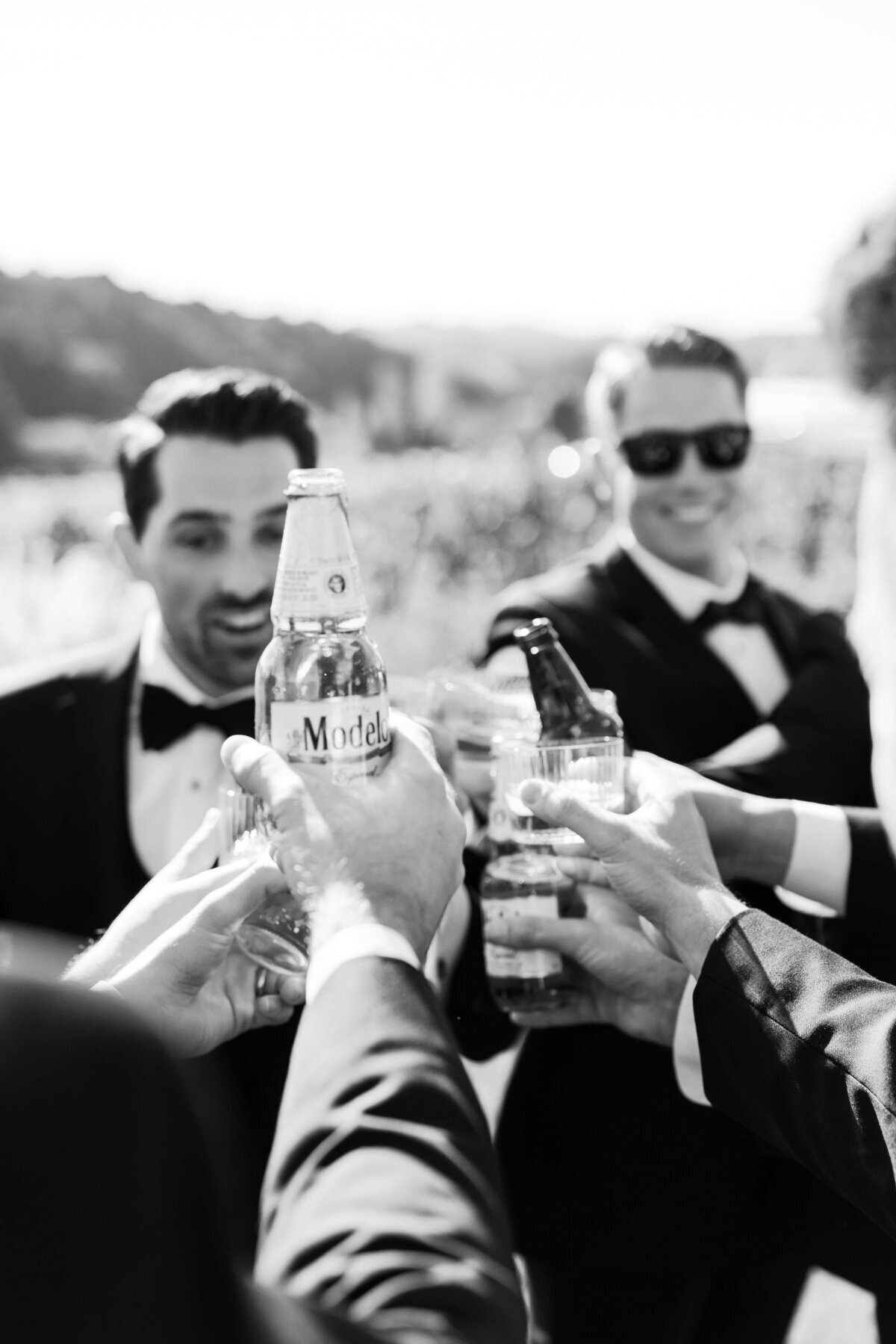 editorial style wedding photography groomsmen toasting
