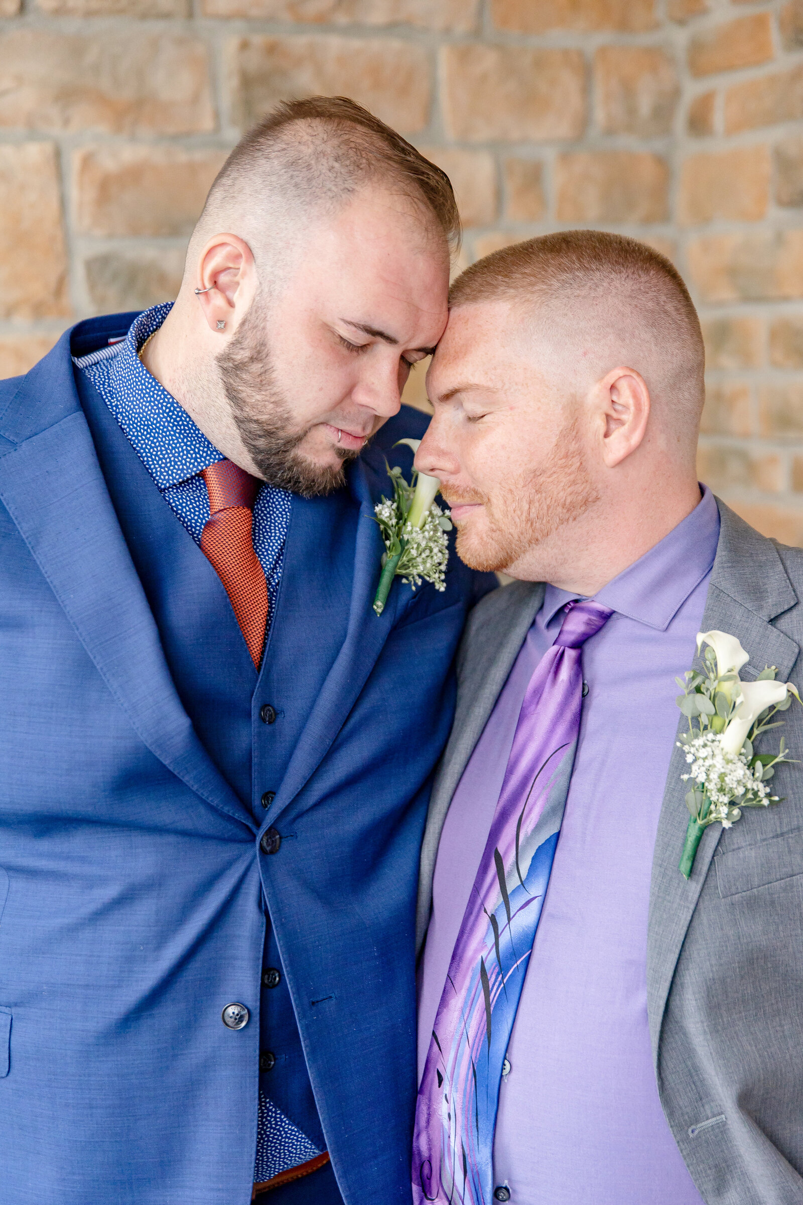 groom and groom with foreheads together