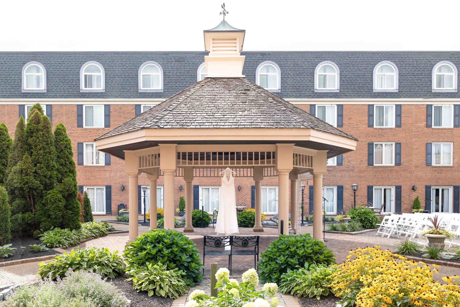Beautifully decorated wedding gazebo surrounded by lush gardens, creating a romantic atmosphere for ceremonies at Christiana Hilton in Wilmington, Delaware.