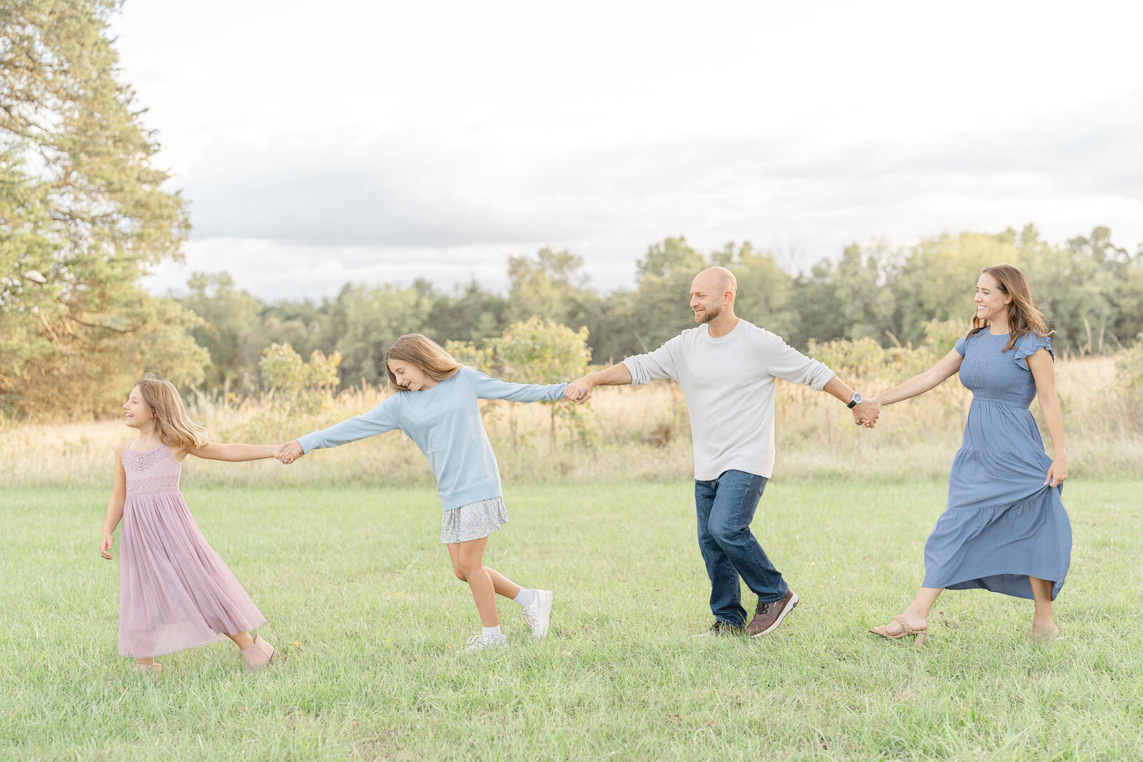 family walk in the field at a park in The Plains, VA