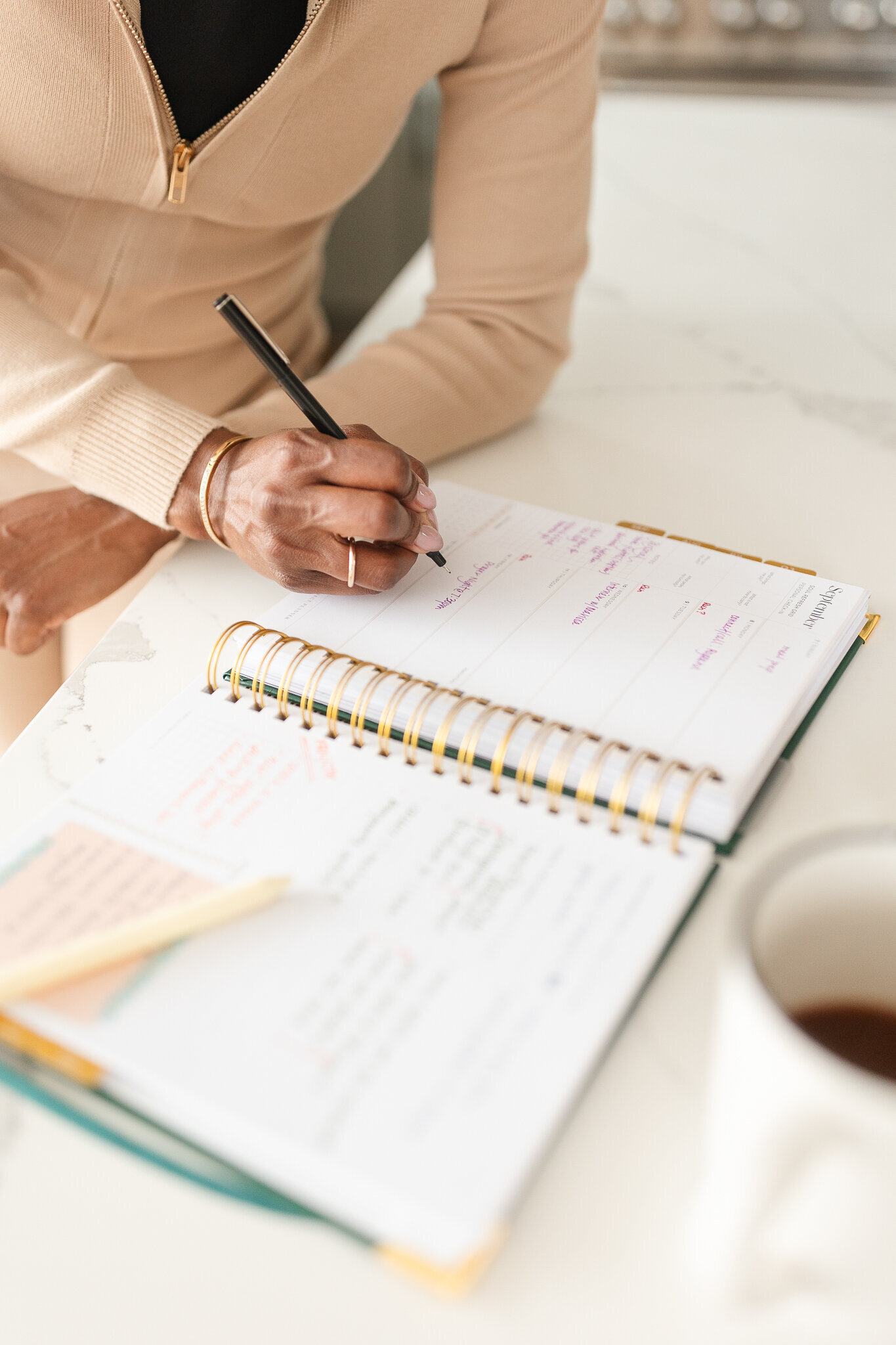 a woman writes in her planner