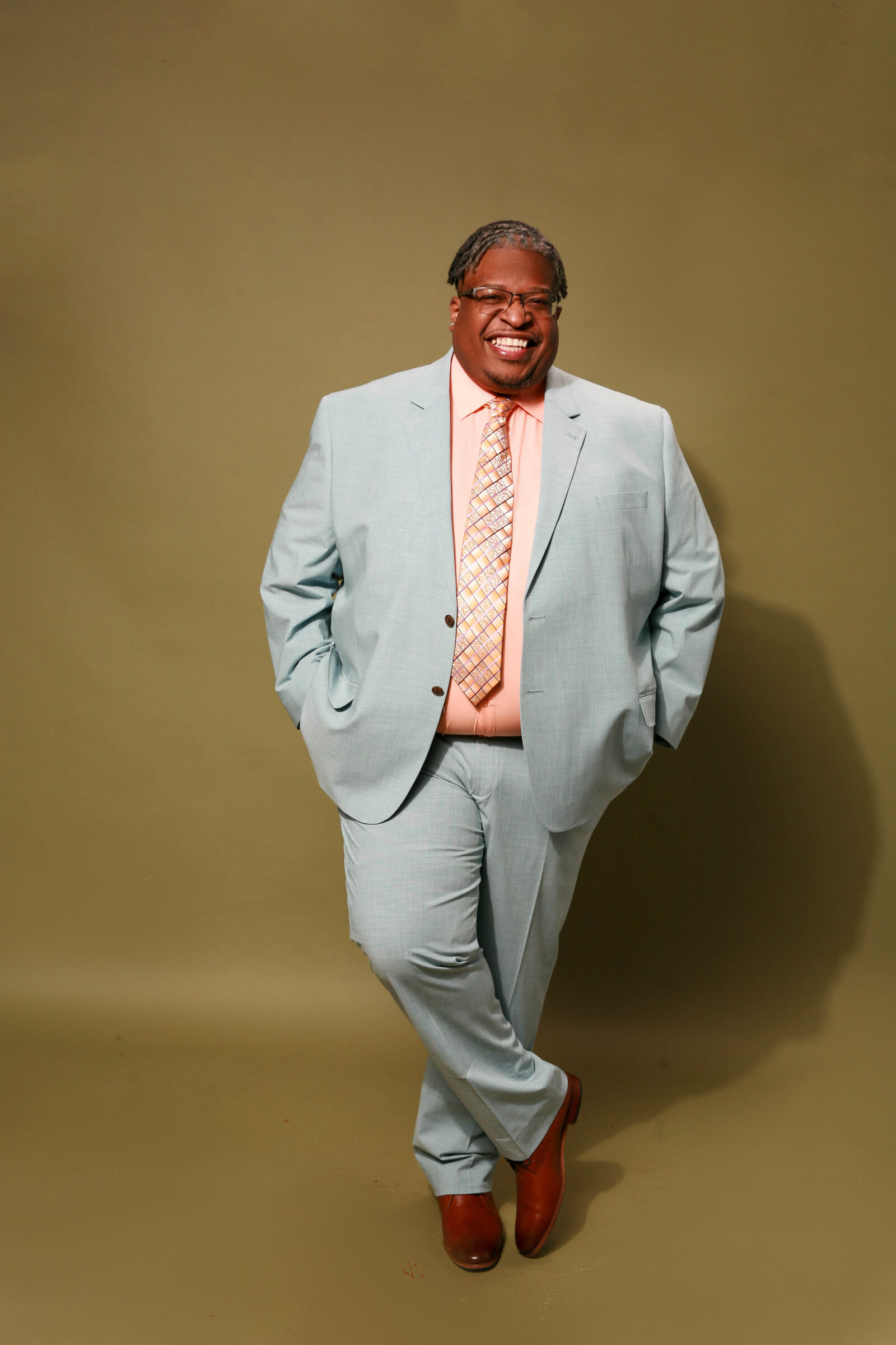 a black male mental health speaker in Massachusetts smiling to the camera
