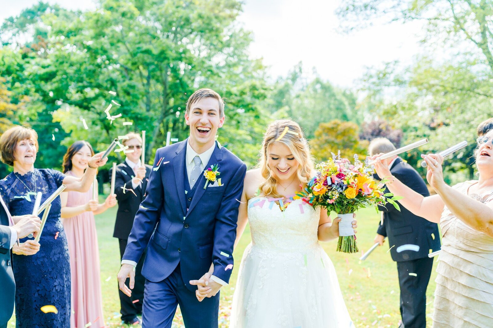 Bride and groom excitedly hold hands and walk down aisle of New Hampshire Wedding