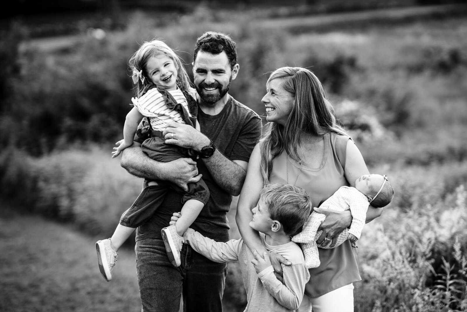 family of five laugh during photoshoot