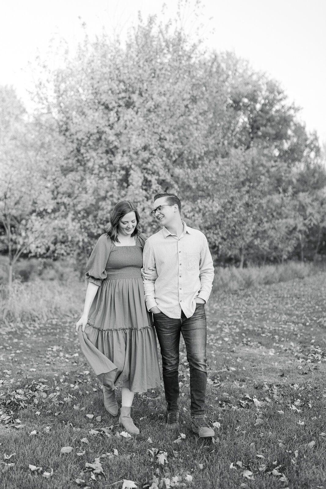 black and white portrait of couple walking during maternity session
