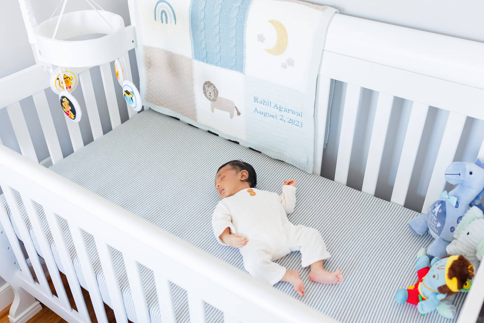 A Northern Virginia newborn boy laying in his crib.