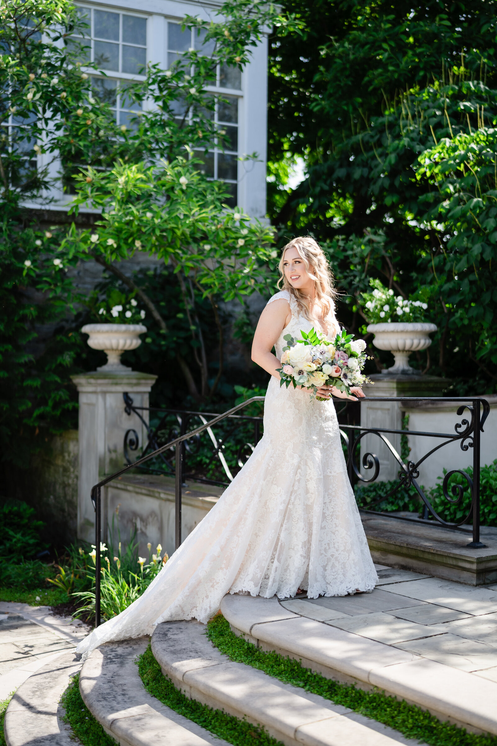 A bride walks up the steps and looks over her shoulder inside the Bride's Garden at the Franklin Park Conservatory