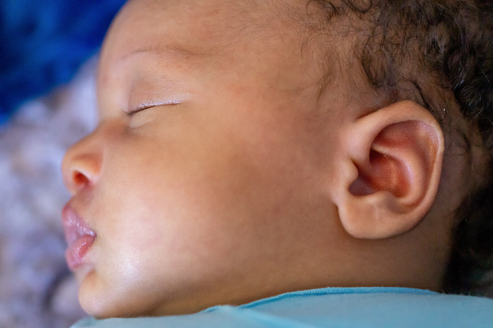 A close-up of a baby boy's face and ear during his Woodbridge newborn photo session.