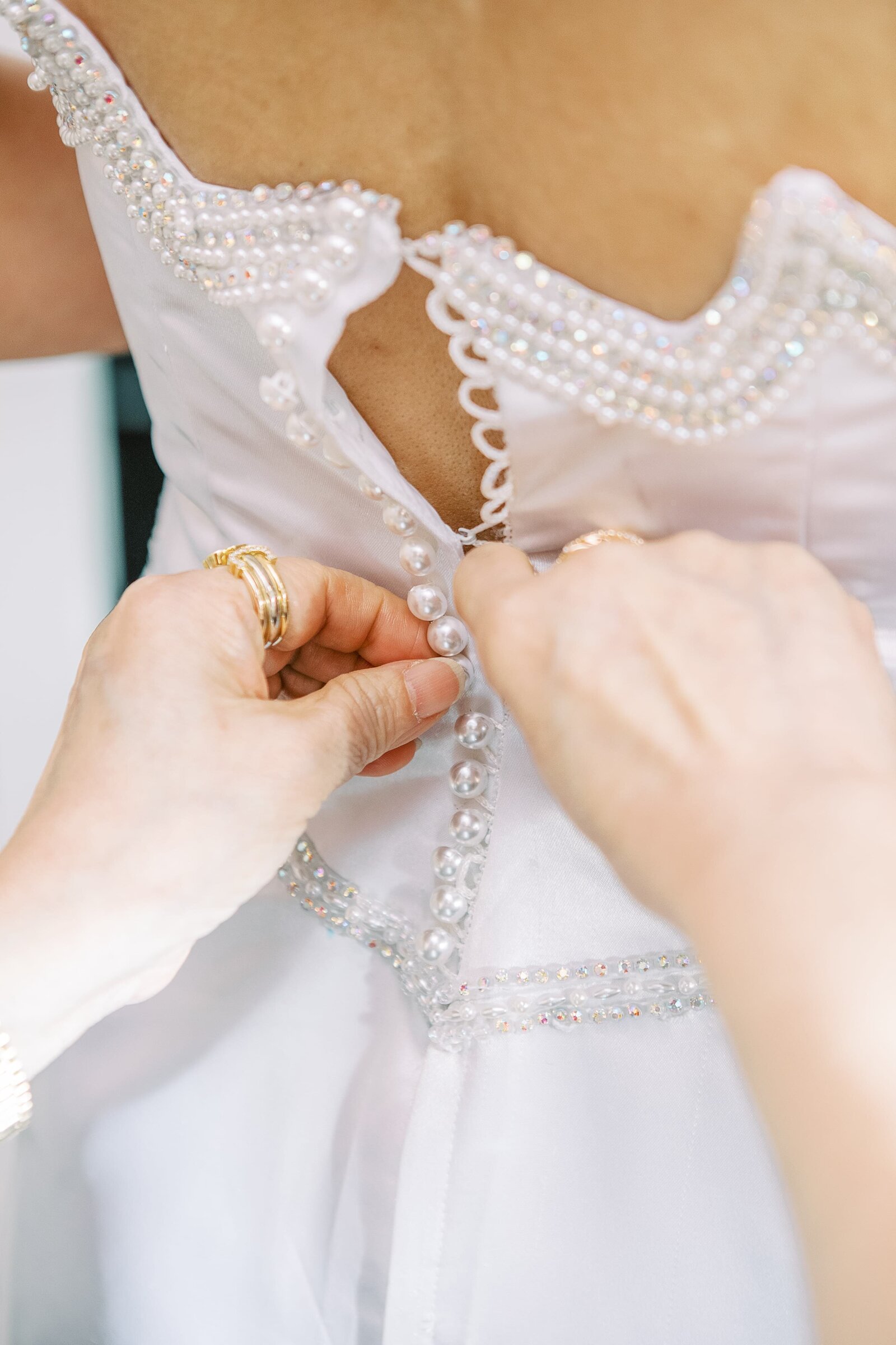 buttoning-brides-wedding-gown