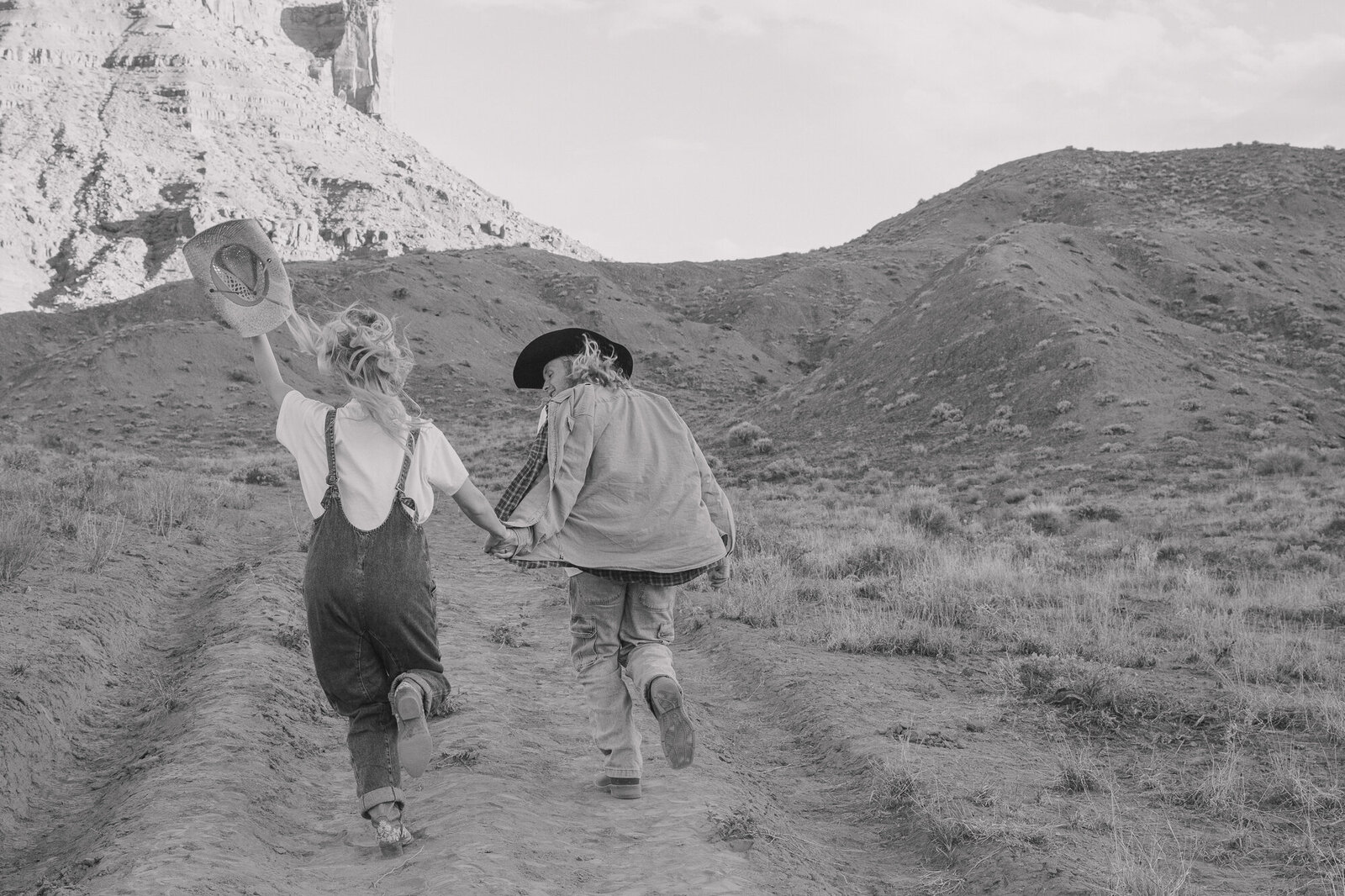 A couple running freely in Moab enjoying their wild love together 
