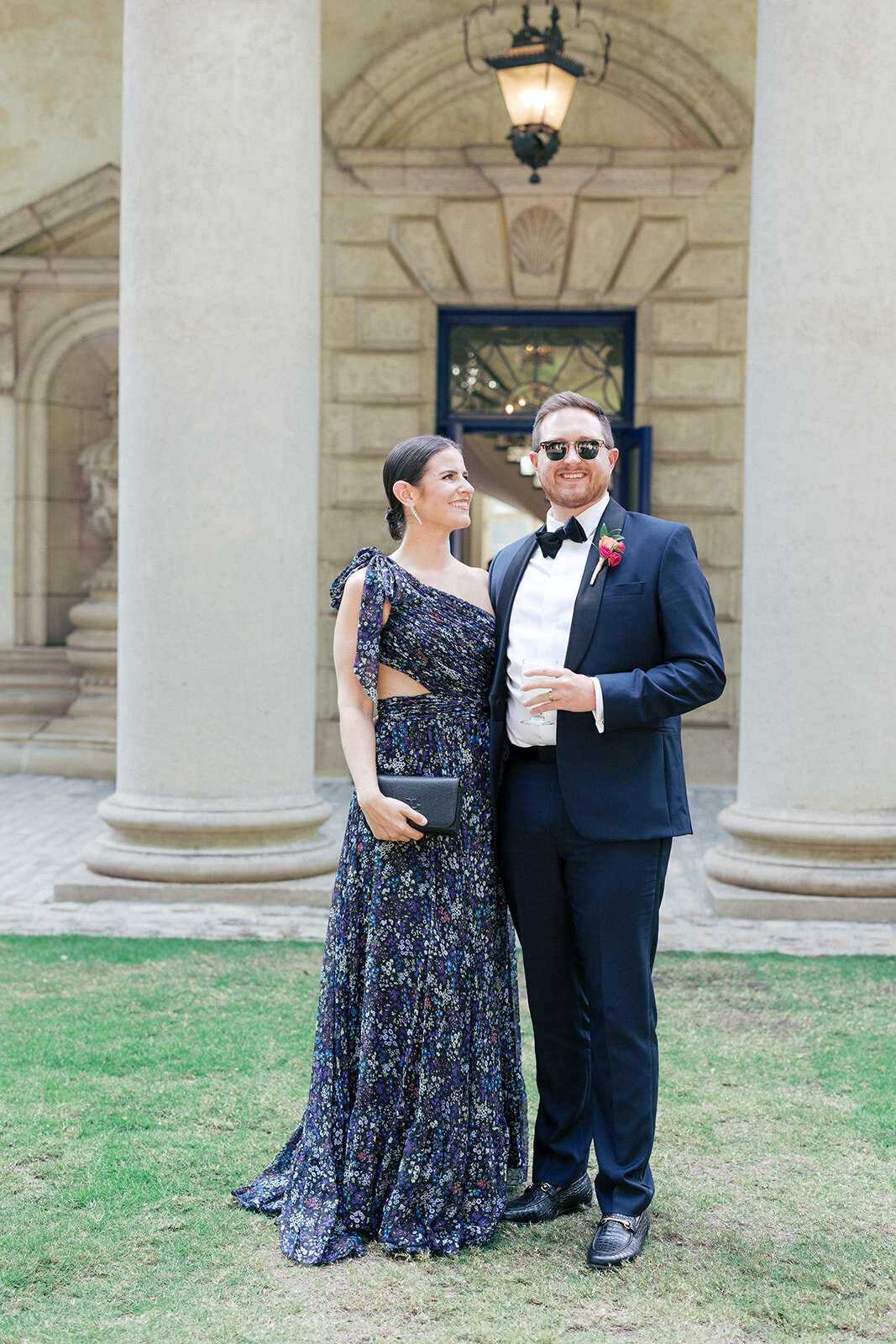 girl looking at guy in blue suit at the swan house on the lawn