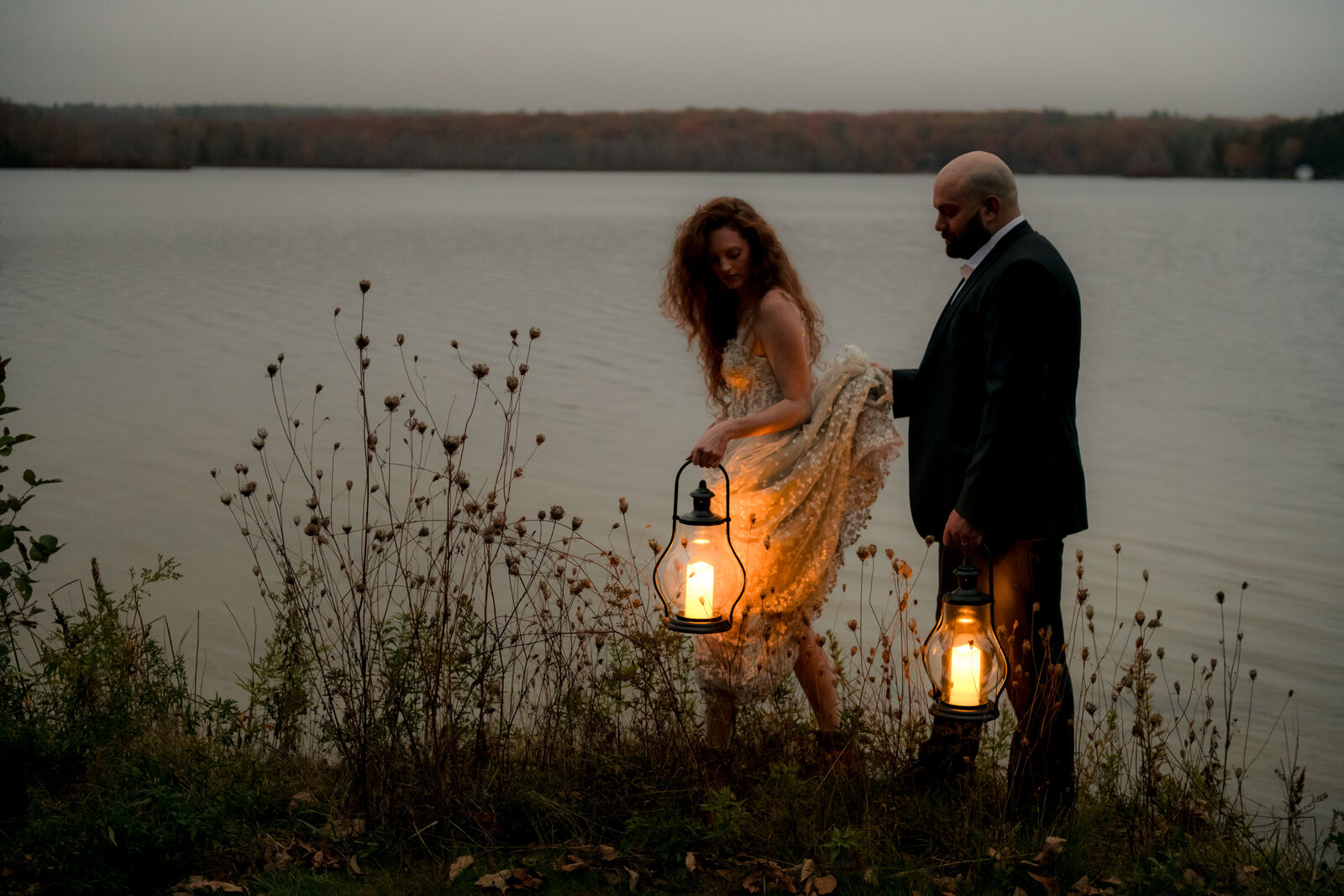 after their elopement the bride and groom escape to a lake at dusk.