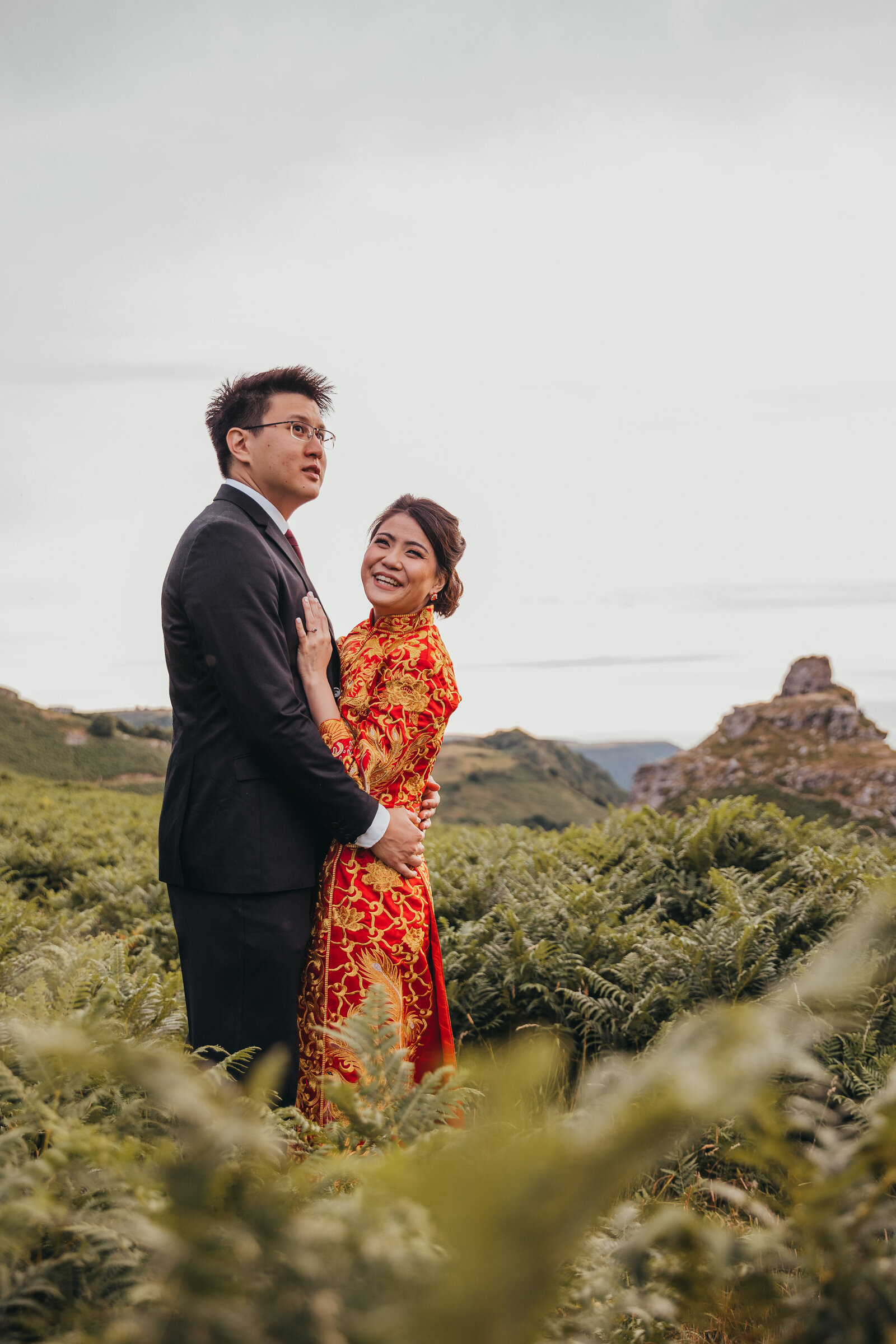couple in traditional wedding attire pose for a photo