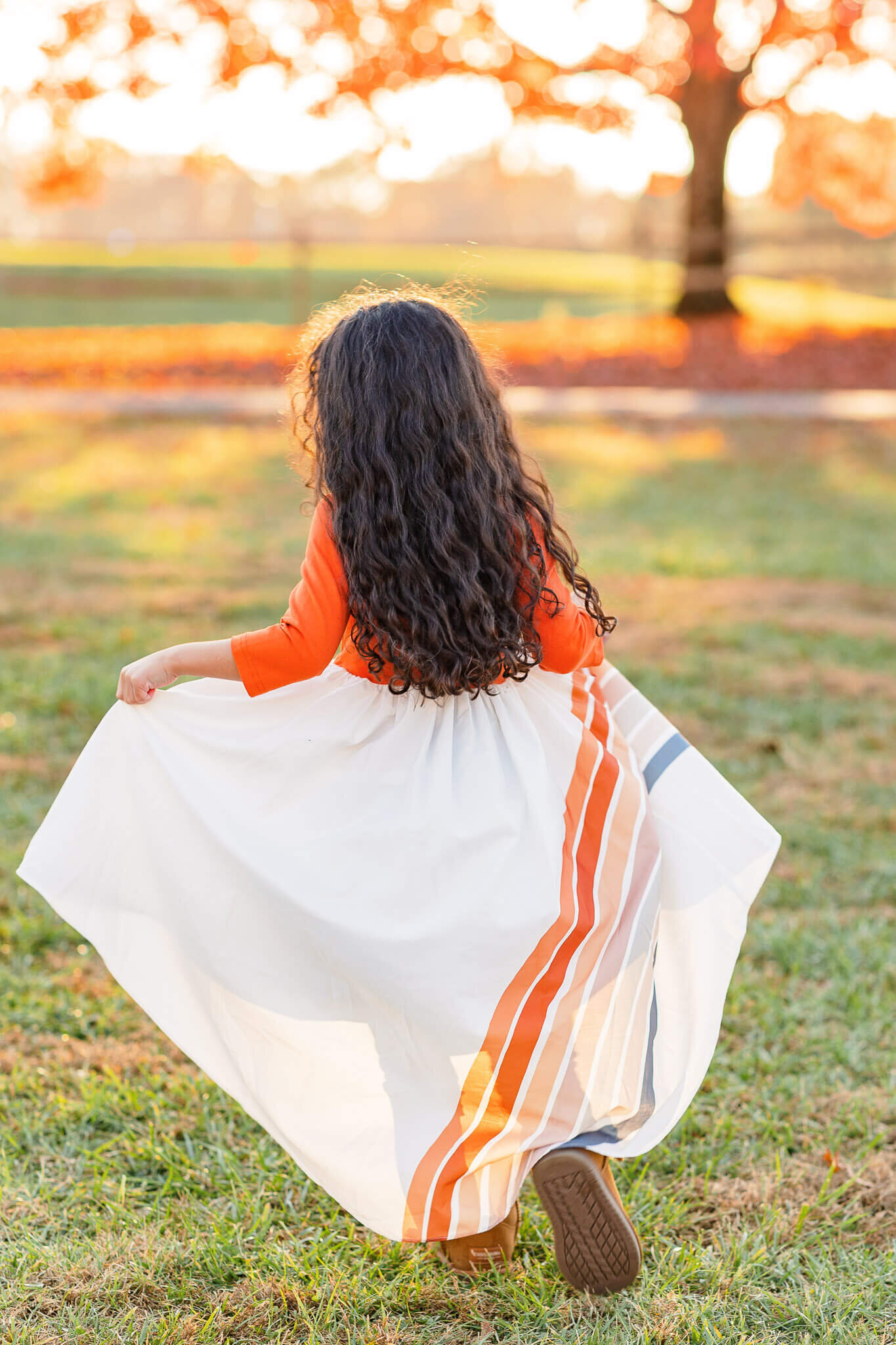 A little girl twirling in her dress