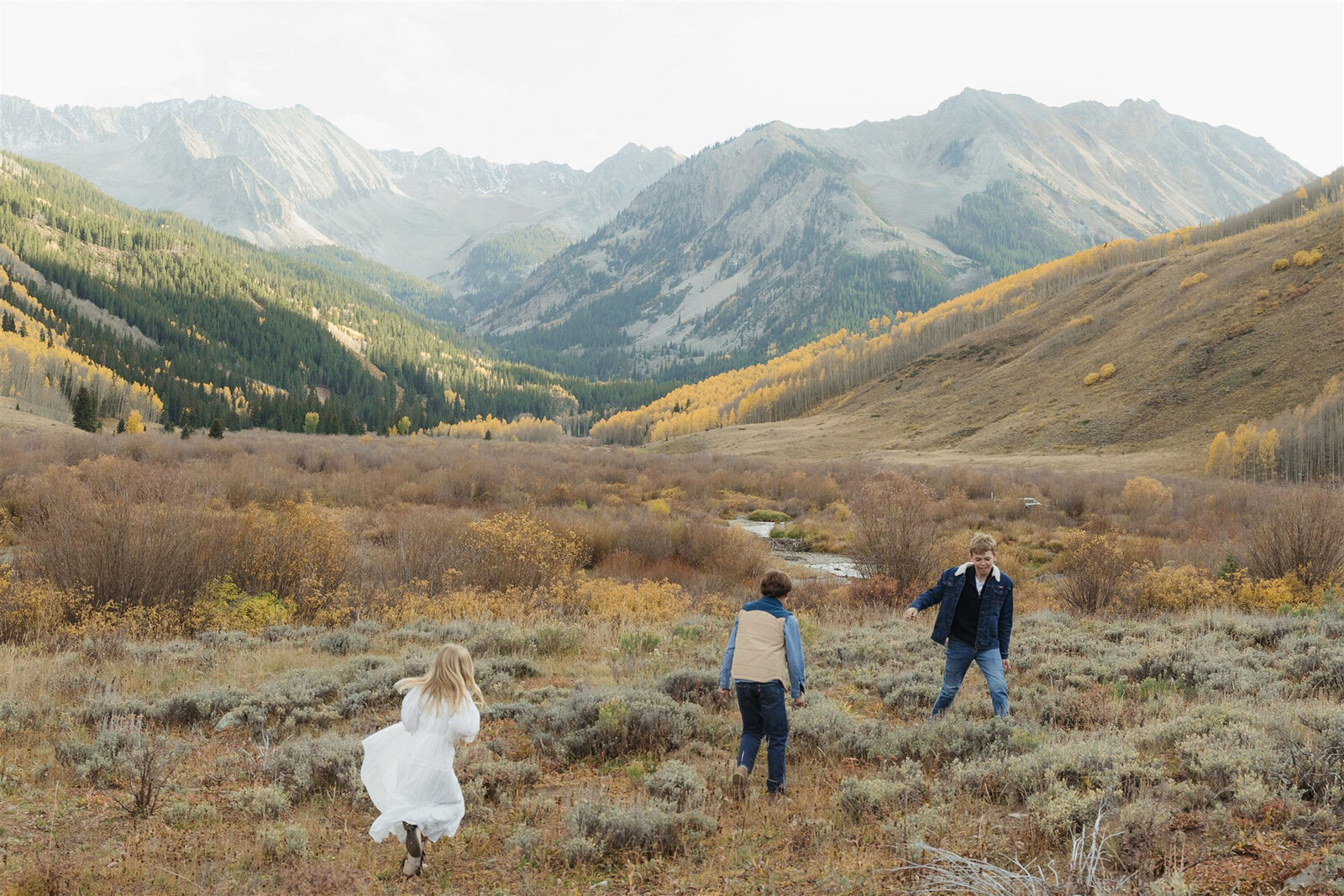 Luxury Aspen family photography — the Stanley family styled in Ralph Lauren–inspired layers with the Rocky Mountains in the background.
