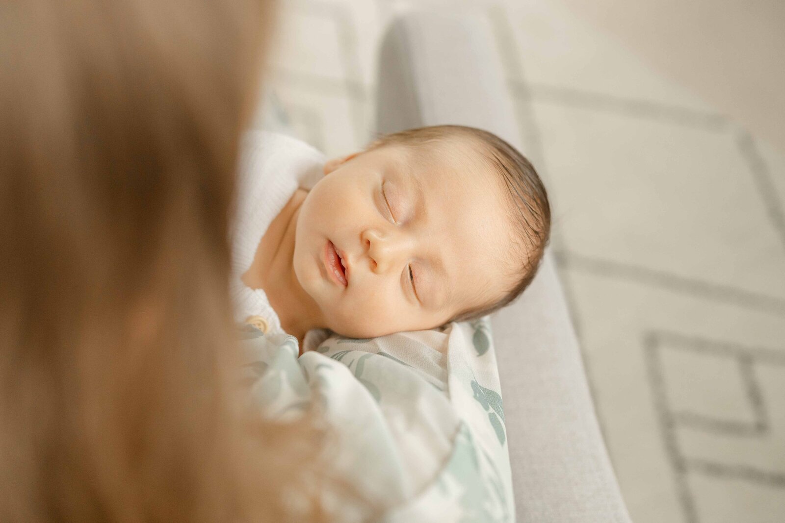 baby boy held by mom during newborn photo in Centreville, Virginia