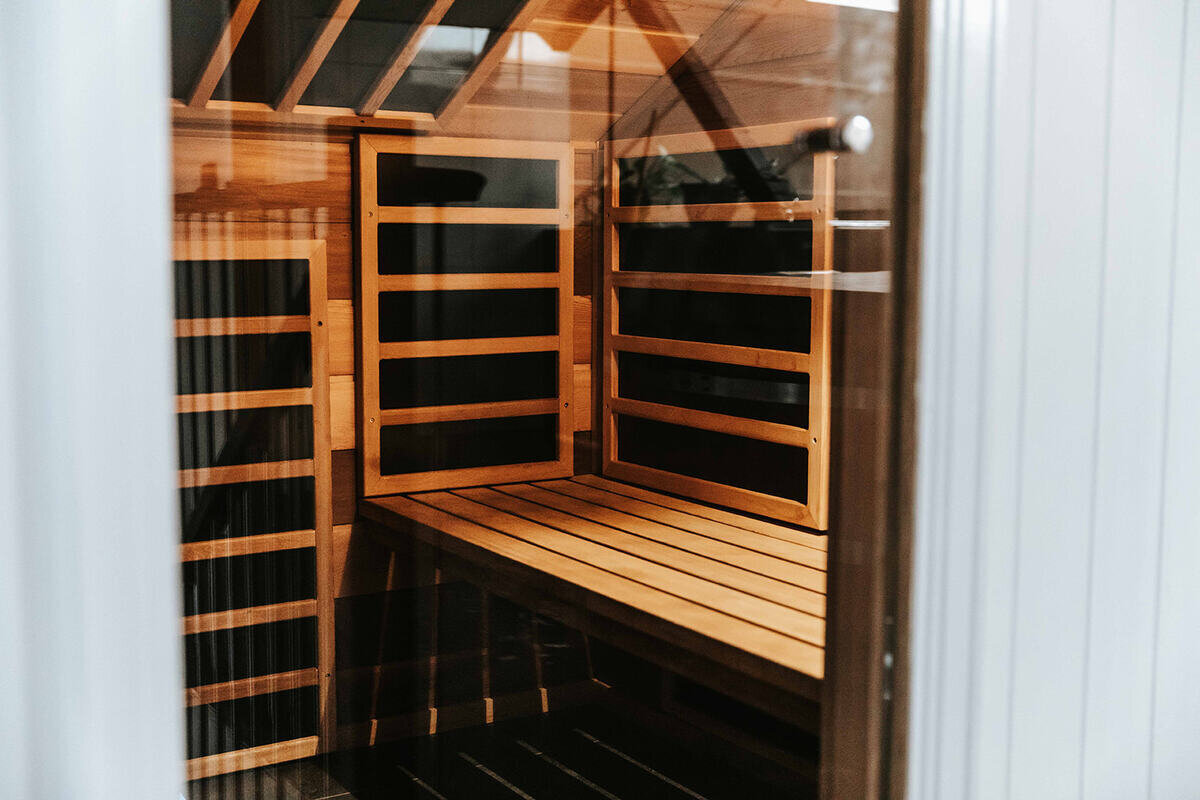 "Interior of a Brunswick gym showing a wooden sauna with a glass door."