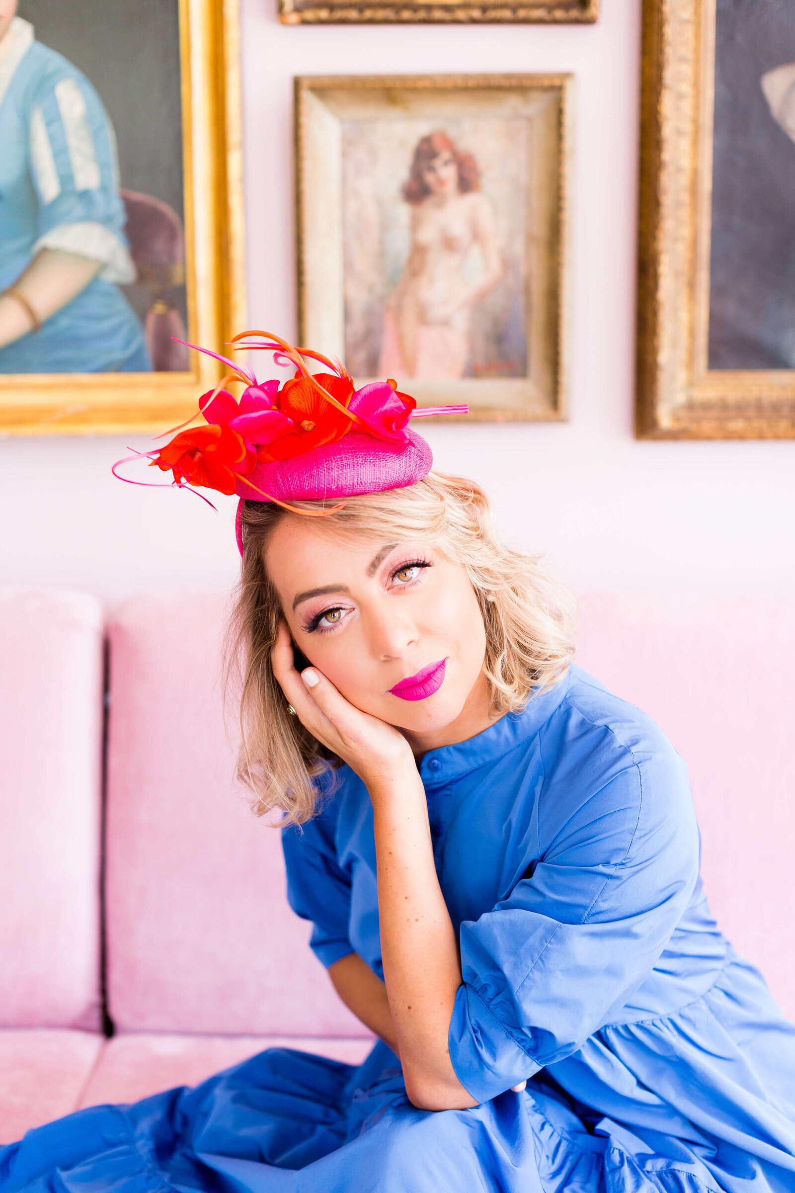 woman posing for camera wearing red hats and blue top