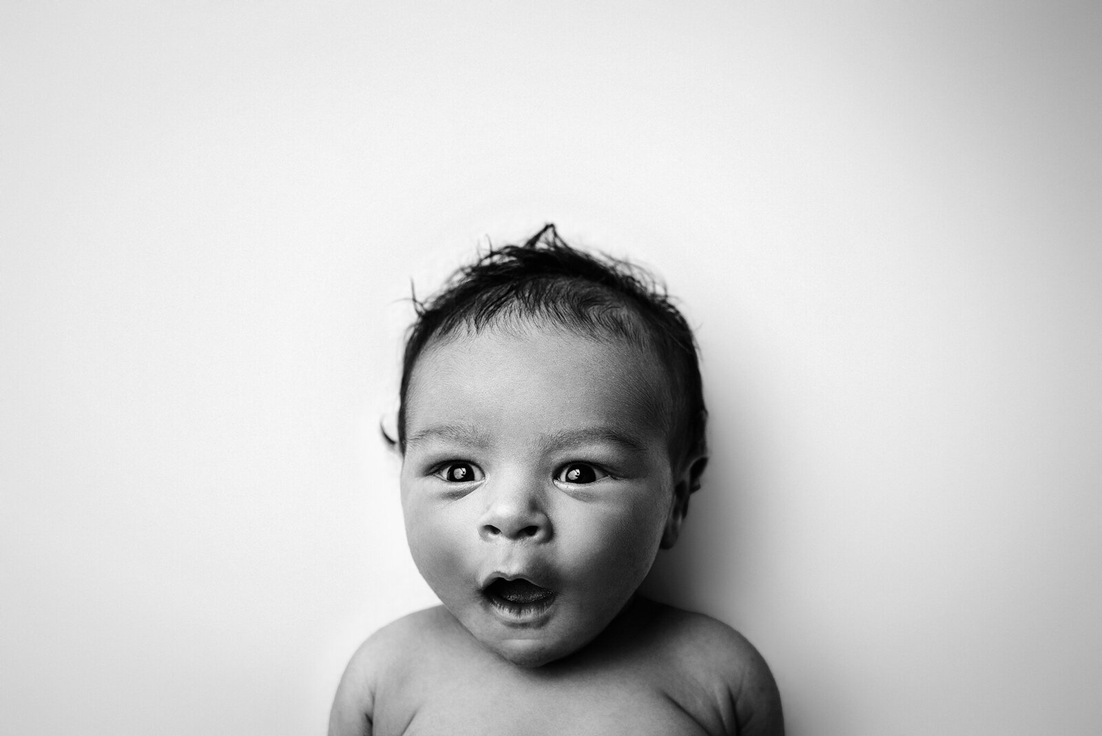 Black and white in home studio newborn facial expression portrait in Jacksonville, FL.