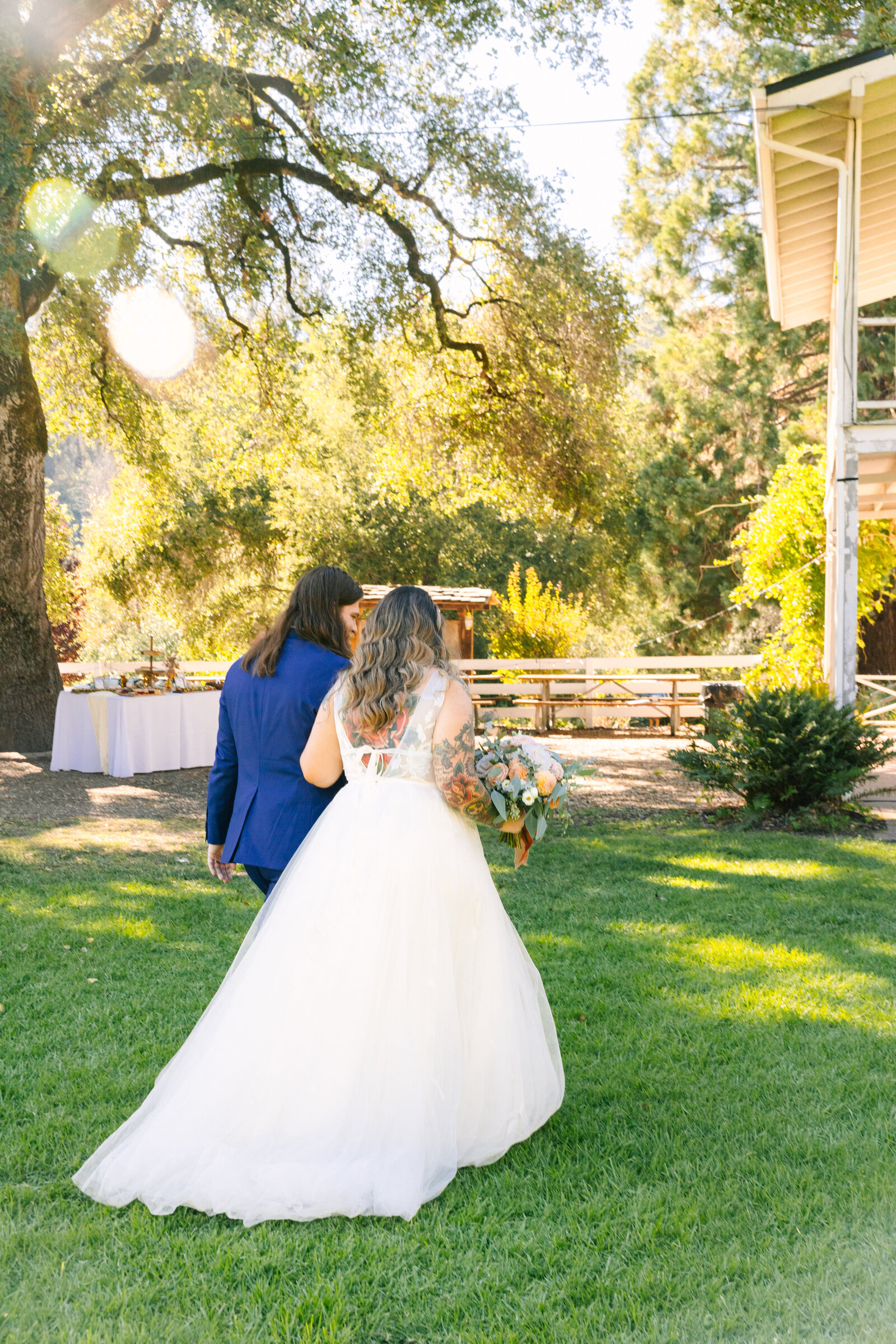 Tattoo bride and groom embrace on their colorful wedding day in Santa Cruz, California.