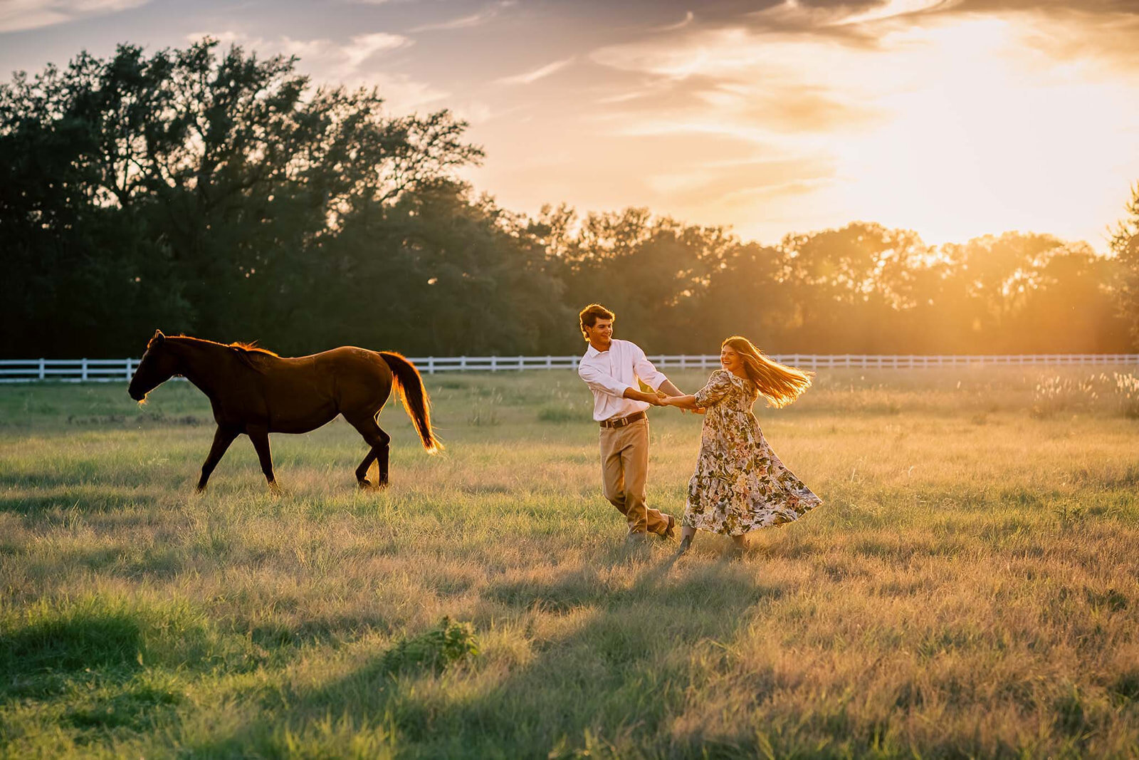 A couple walking with a horse during sunset in the Texas Hill Country, captured by CMH Studios, San Antonio luxury wedding photographer.