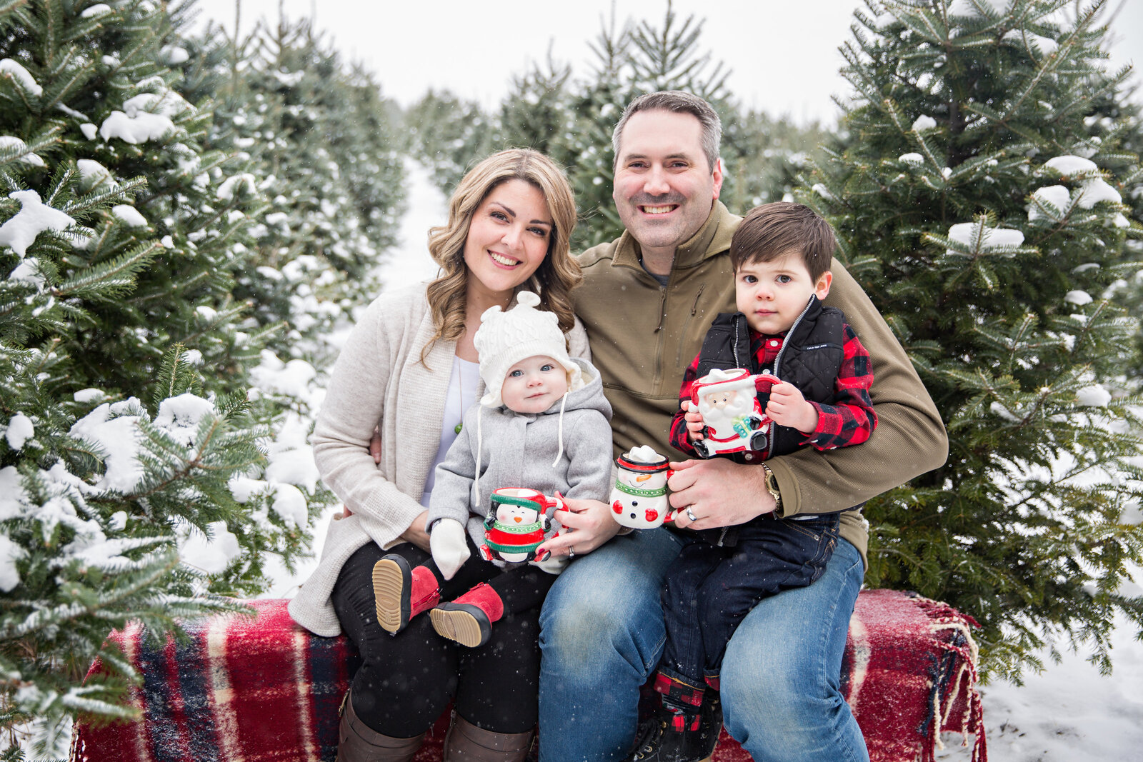 family with 2 children at snowy tree farm in Hamilton